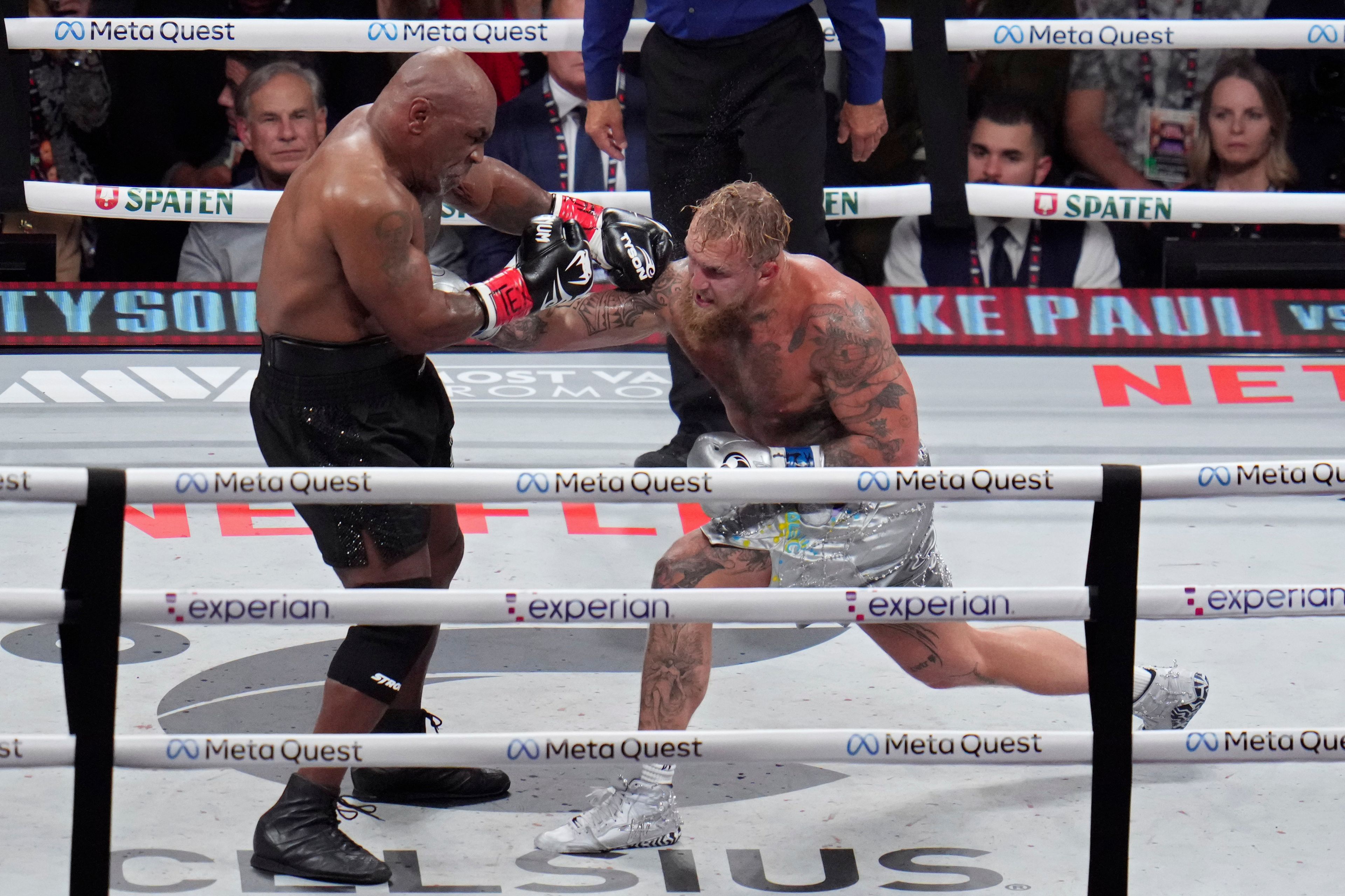 Jake Paul hits Mike Tyson during their heavyweight boxing match, Friday, Nov. 15, 2024, in Arlington, Texas. (AP Photo/Julio Cortez)