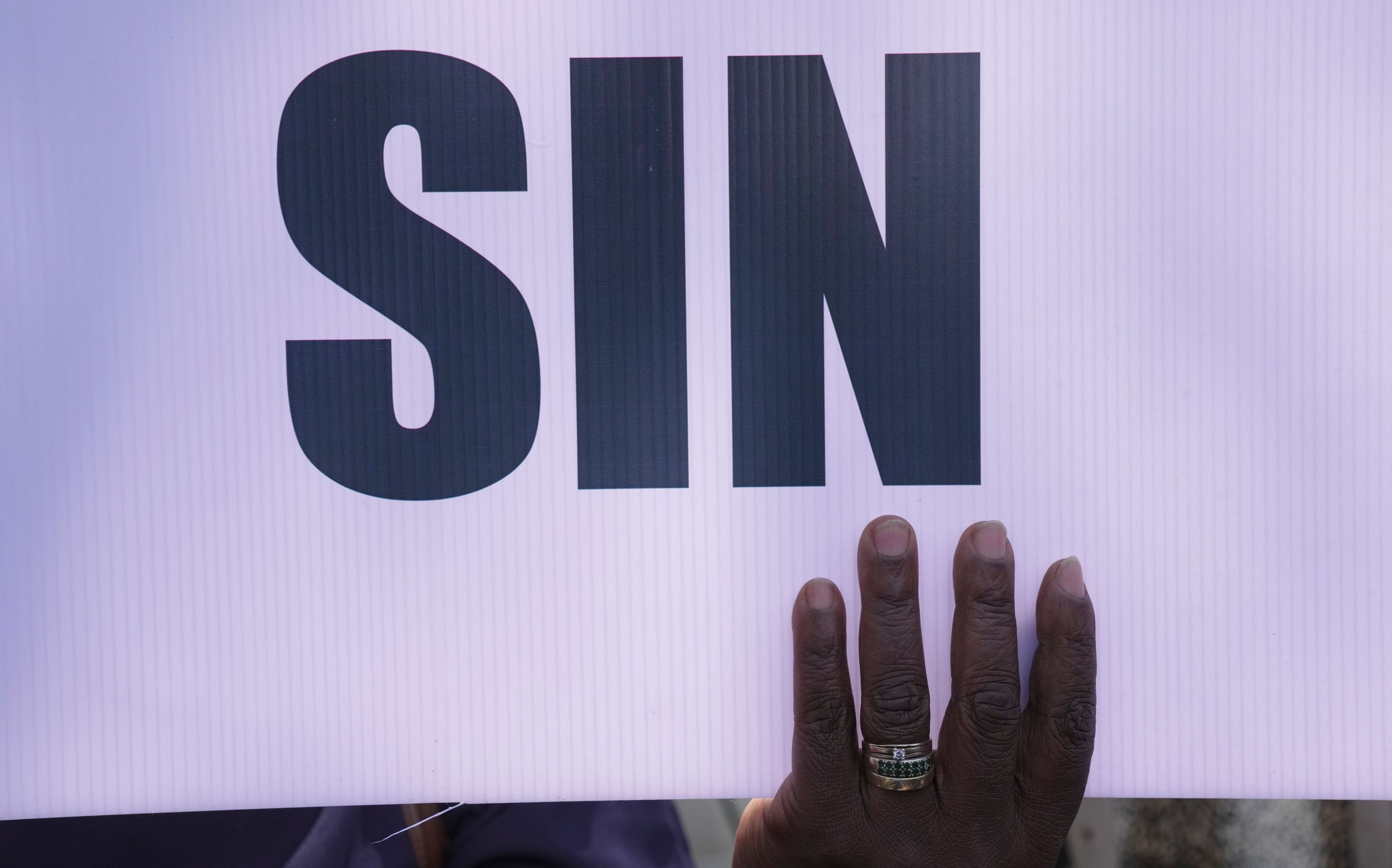 A member of the United Methodist Church in Zimbabwe holds a placard while holding a protest at the church premises in Harare, Thursday, May 30, 2024. The protests denouncing homosexuality and the departure of the church from the scriptures and doctrine, come barely a month after the United Methodist Church Worldwide General Conference held in North Carolina, US repealed their church's longstanding ban on LGBTQ clergy, removing a rule forbidding "self-avowed practising homosexuals" from being ordained or appointed as ministers.