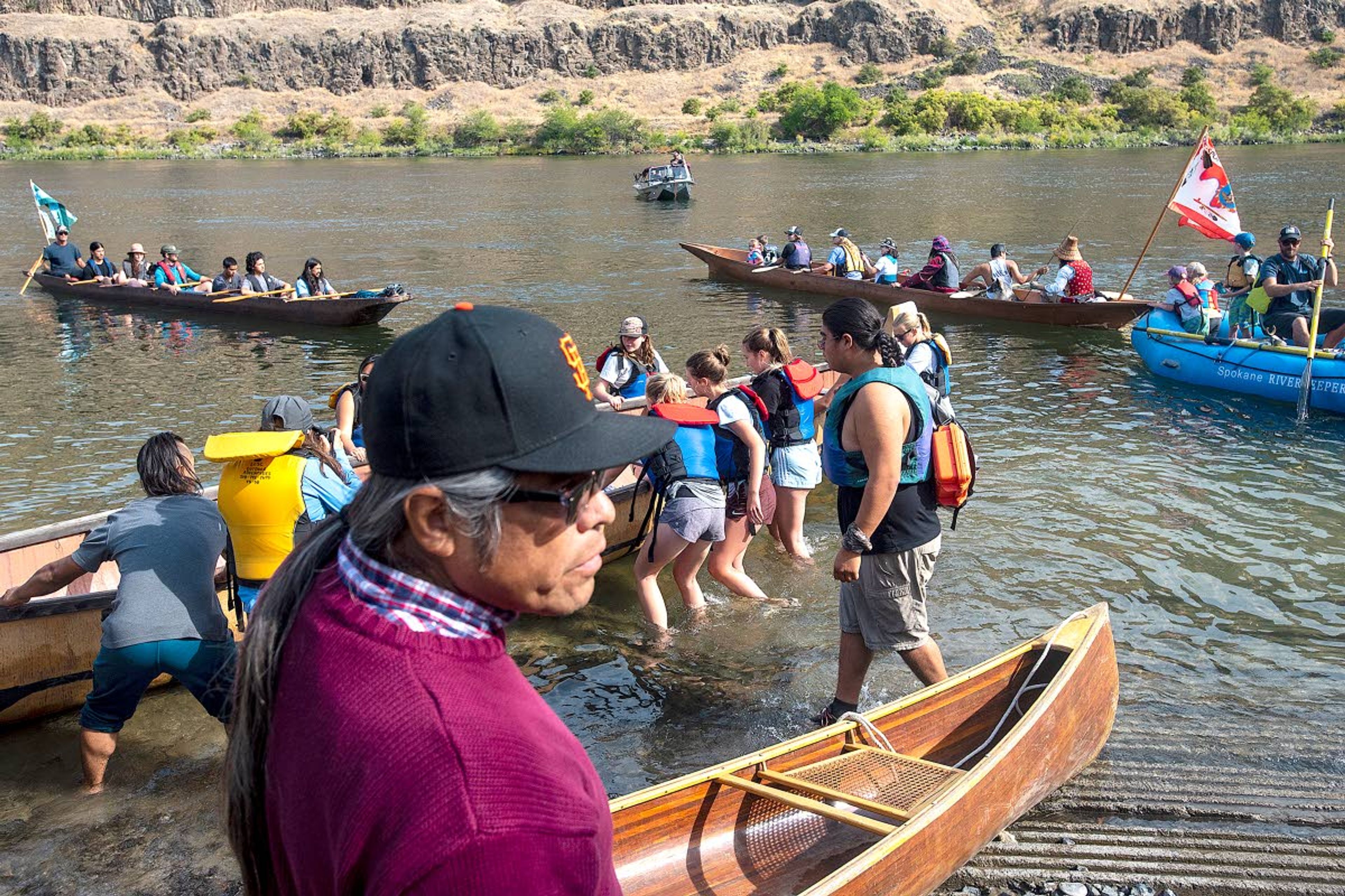 Paddlers enter the water at the Asotin Boat Ramp on their way to meet up in a flotilla during the Nimiipuu River Rendezvous on Saturday along the Snake River.