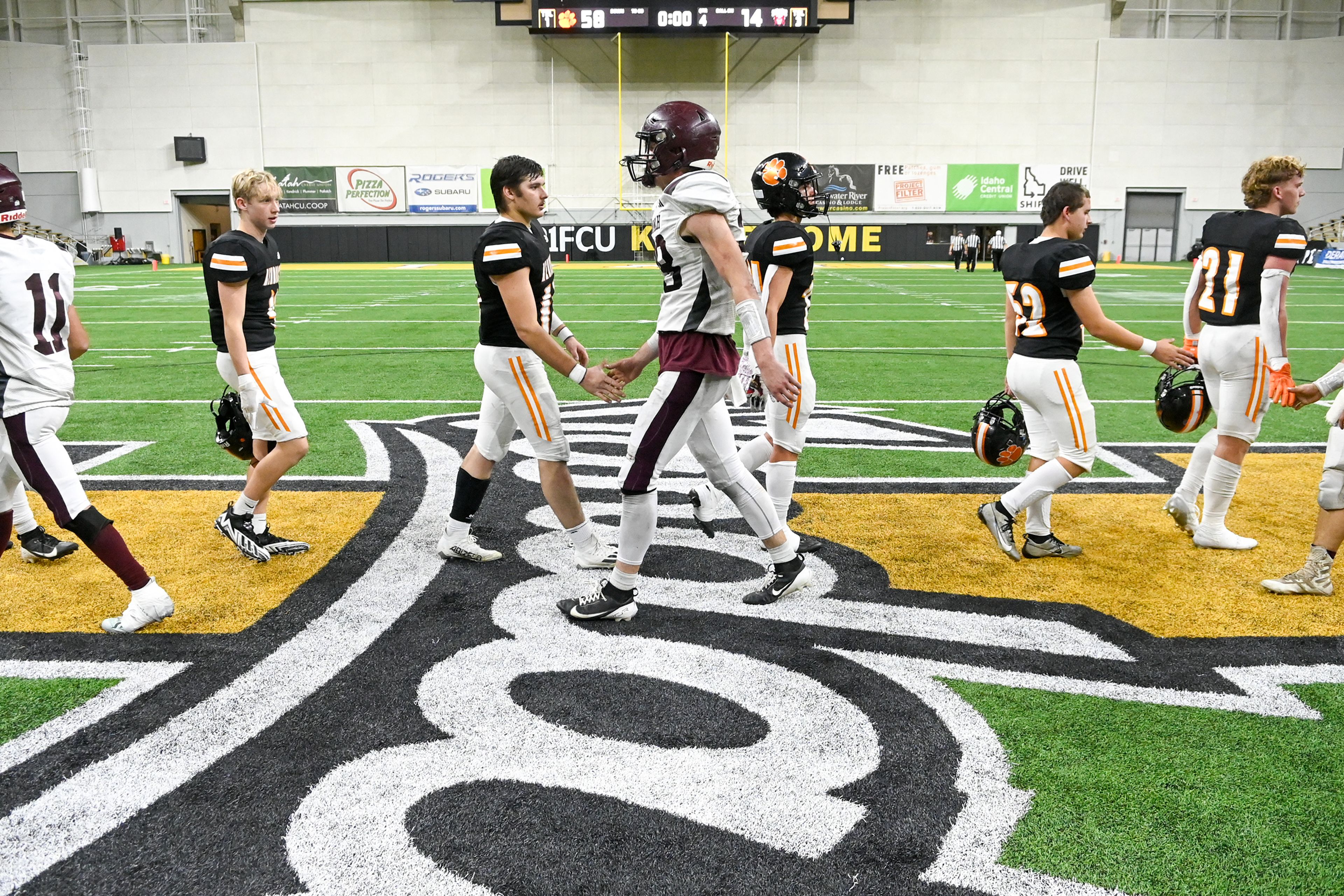 Kendrick and Kamiah players shake hands after Kendrick’s victory in their Idaho Class 2A state quarterfinal game at the P1FCU Kibbie Dome in Moscow.