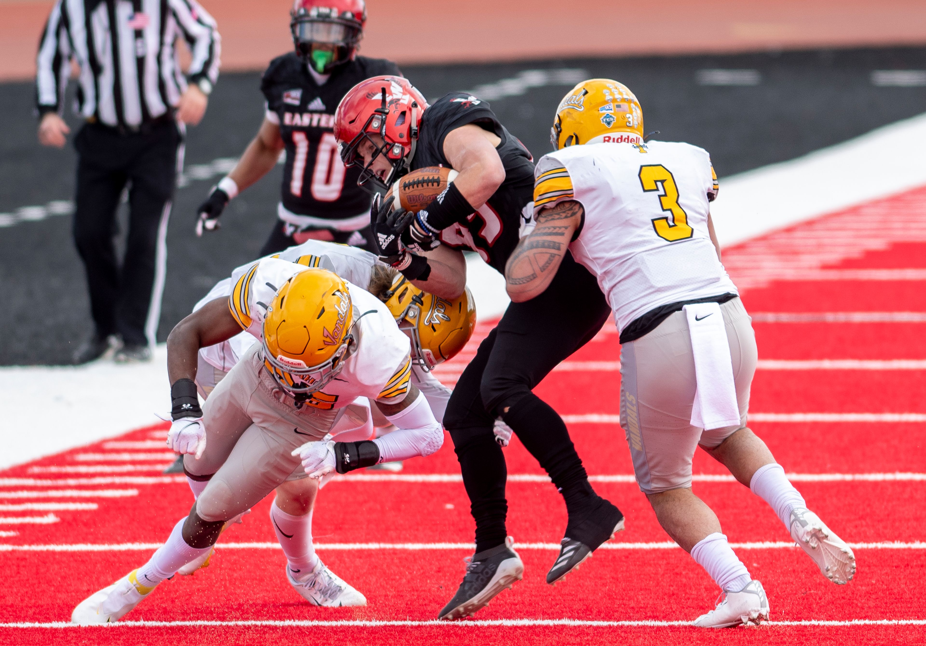 A trio of Idaho defenders tackle Eastern Washington wide receiver Efton Chism III (89) during the third quarter of a Big Sky Conference matchup at Roos Field on Saturday afternoon. Eastern Washington defeated Idaho 38-31.