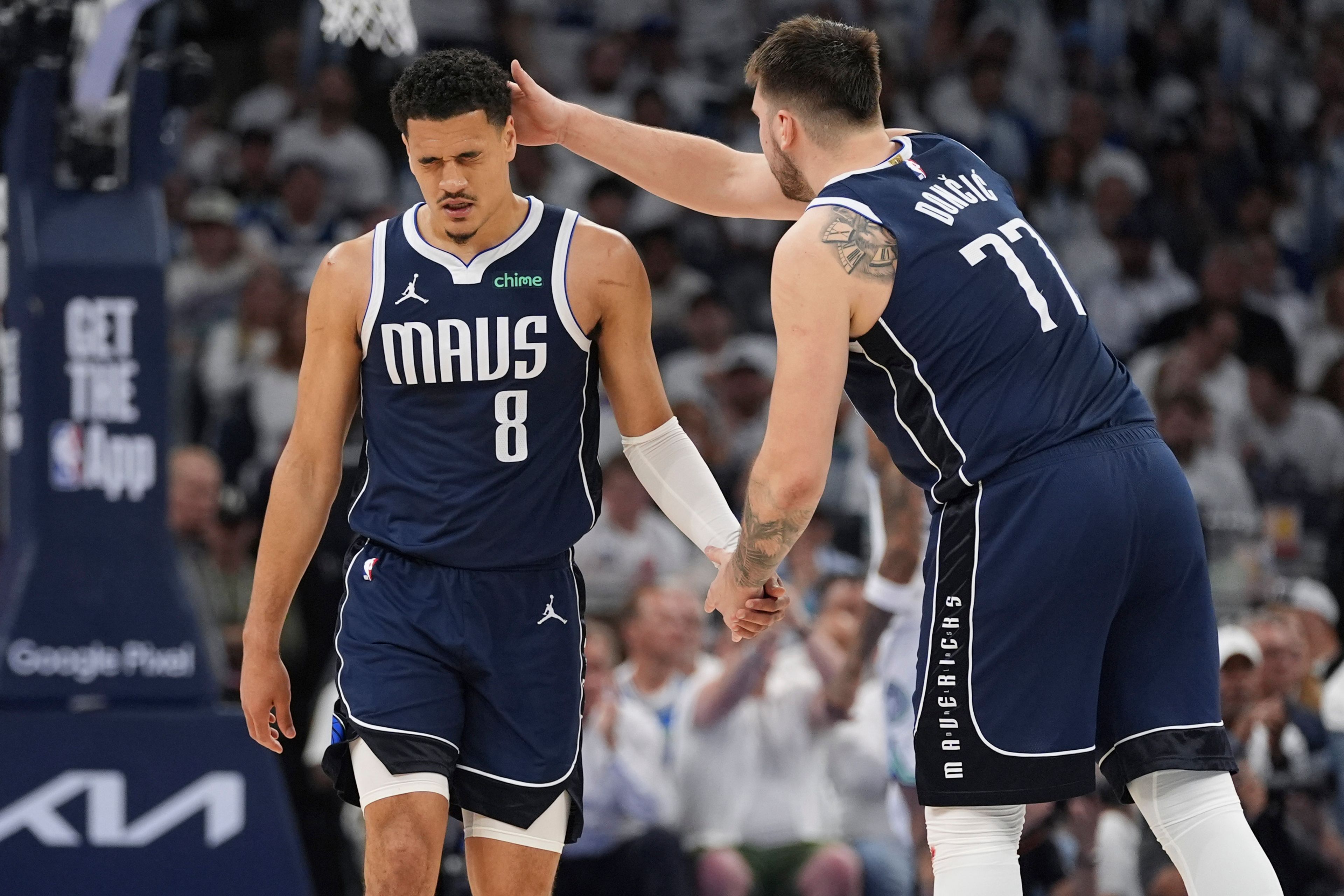 Mavericks guard Josh Green, left, is encouraged by teammate Luka Doncic, right, during the second half in Game 1 of the Western Conference finals against the Timberwolves on Wednesday in Minneapolis.