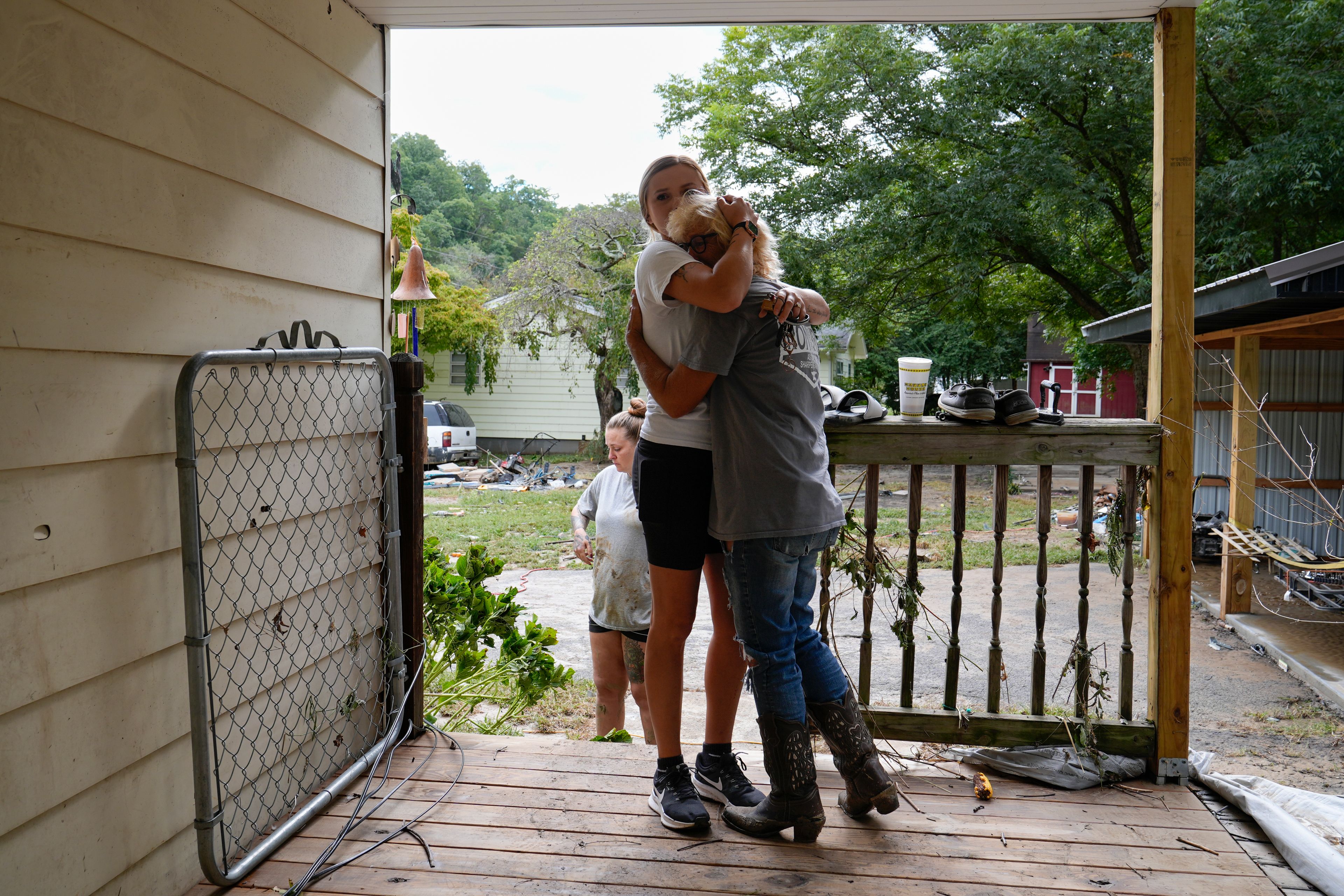 Ashlie Salliotte, left, hugs Janet Sams, right, at Sams' flood-damaged home along River Road, in the aftermath of Hurricane Helene, Saturday, Sept. 28, 2024, in Newport, Tenn. (AP Photo/George Walker IV)