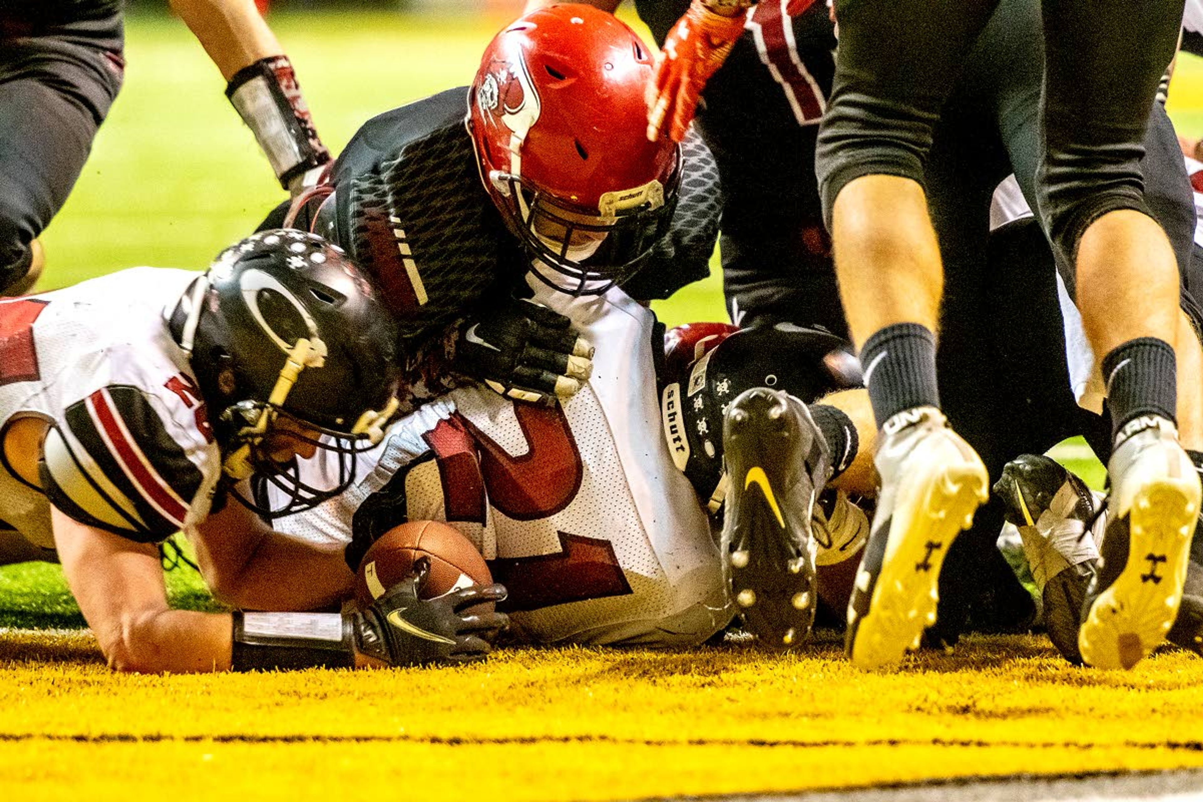 Oakley’s Isaac Mitton (left) dives in from the side to recover a Prairie fumble less than a yard away with 36 seconds remaining in the fourth quarter of a Class 1A Division I state semifinal game Friday at the University of Idaho’s Kibbie Dome.