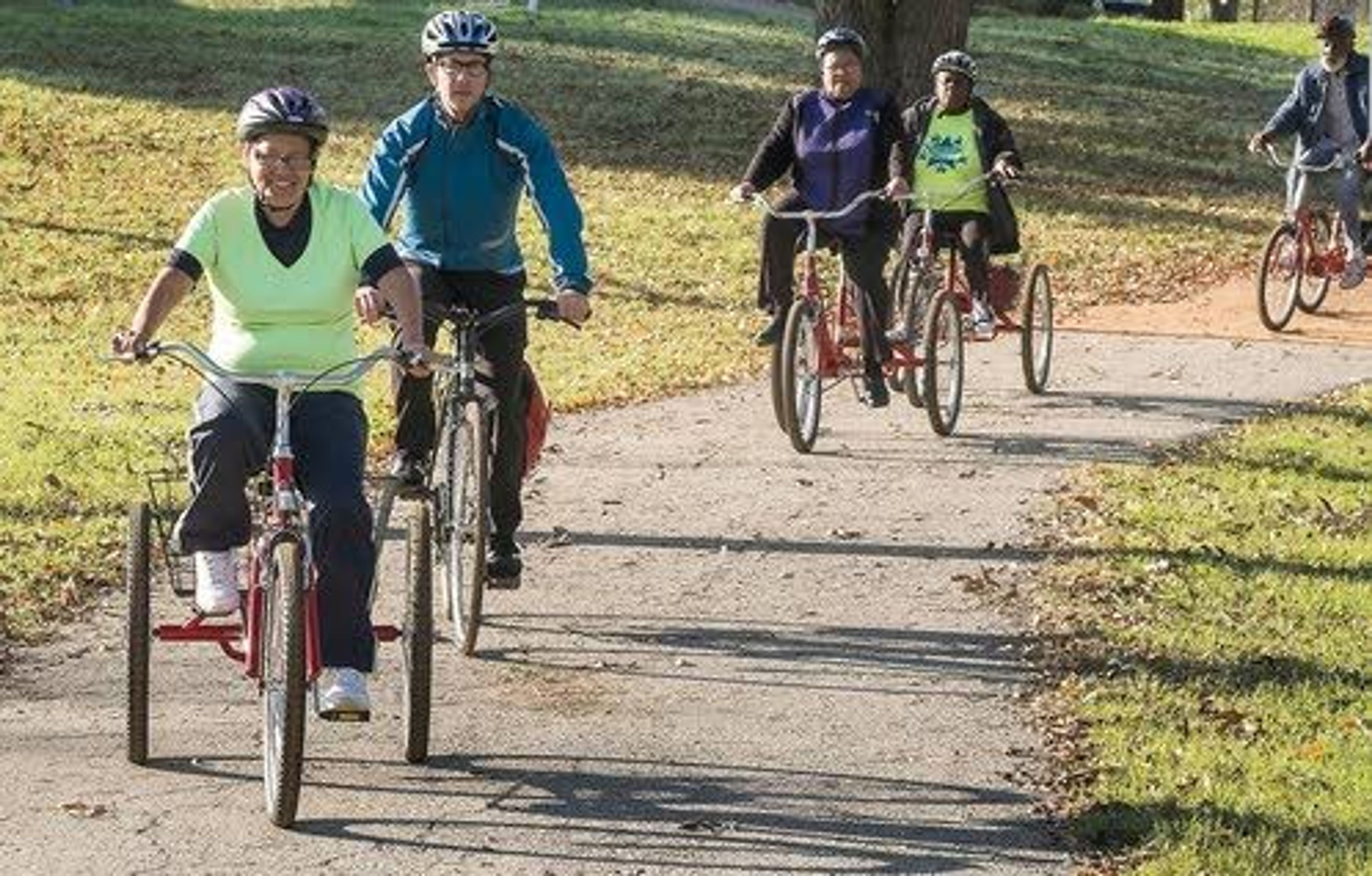 Maria G. Pena, 63, (left) leads the group of senior riders as Christopher Stranton, executive director and founder of the Ghisallo Cycling Initiative, (second from left) follows along during a ride from the Conley-Guerrero Senior Activity Center Dec. 8 in Austin, Texas.