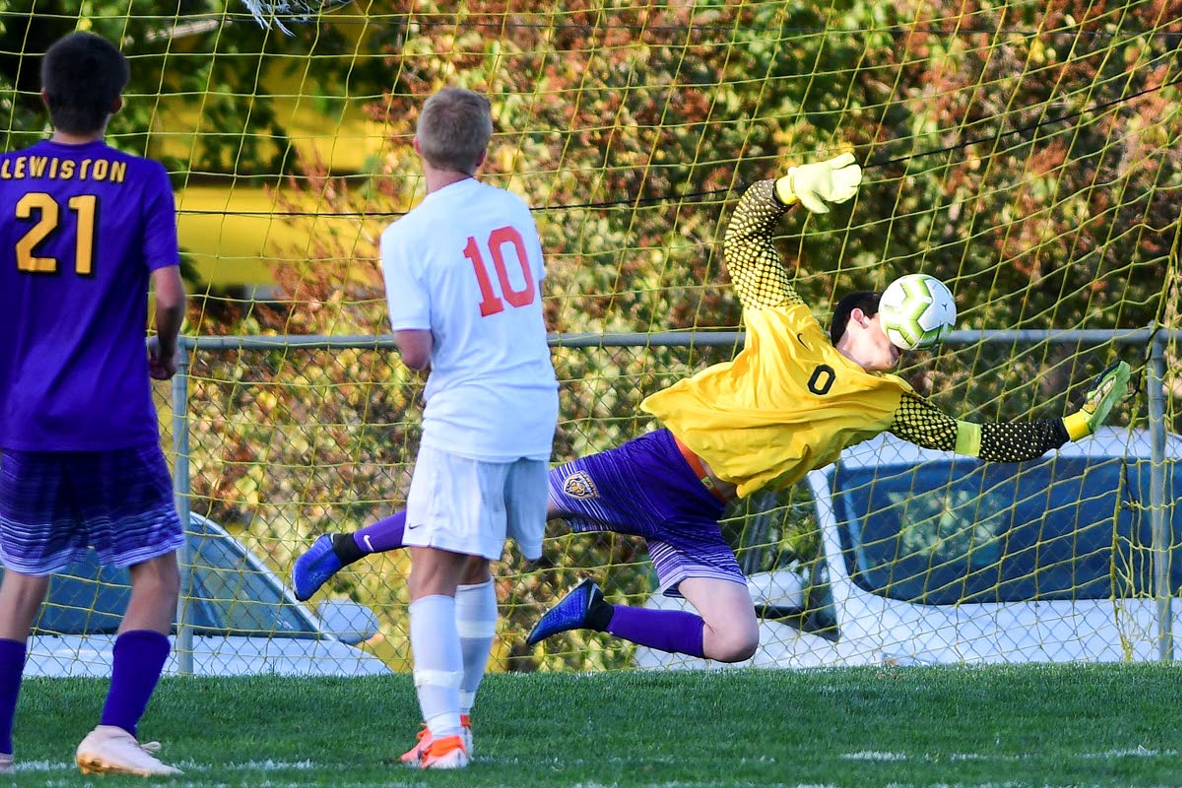 Tribune/Pete CasterLewiston goalkeeper Nikko Vega uses his face to make a save on a shot by Post Falls’ Mckie Gregory (center) as Leighton Shell looks on during the second half of a 5A Inland Empire League soccer game Tuesday.