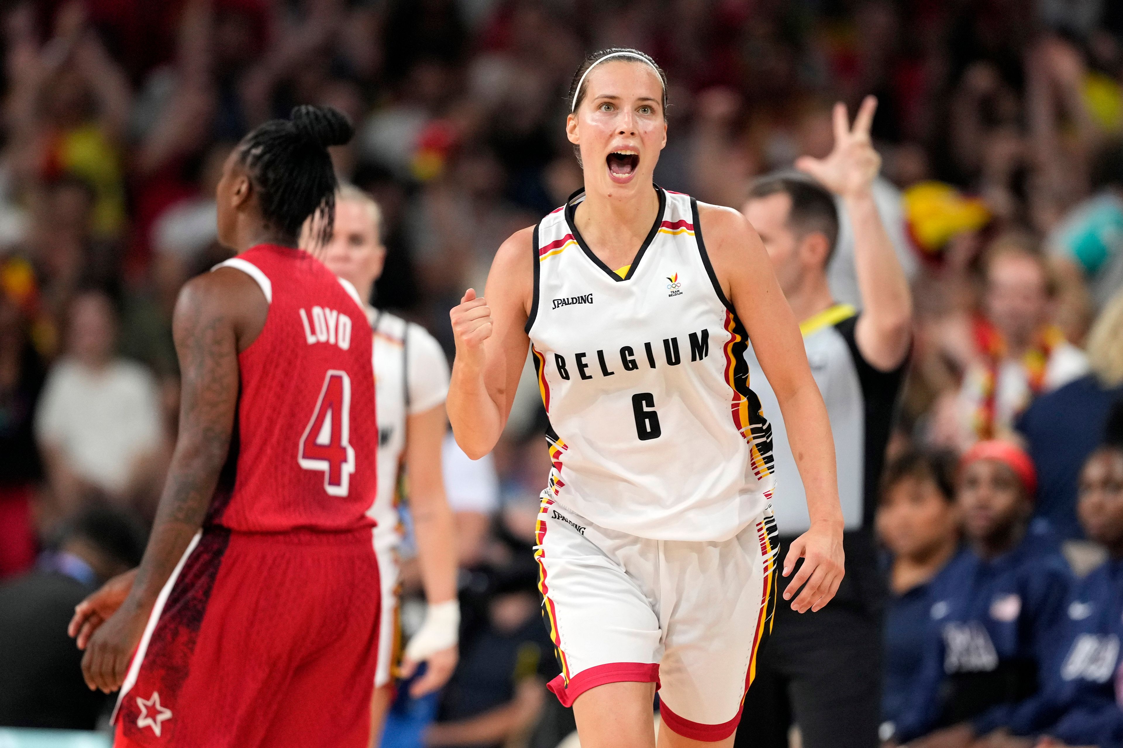 Belgium's Antonia Delaere, right, celebrates after making a three-point basket as United States' Jewell Loyd walks away during a women's basketball game at the 2024 Summer Olympics, Thursday, Aug. 1, 2024, in Villeneuve-d'Ascq, France. (AP Photo/Michael Conroy)