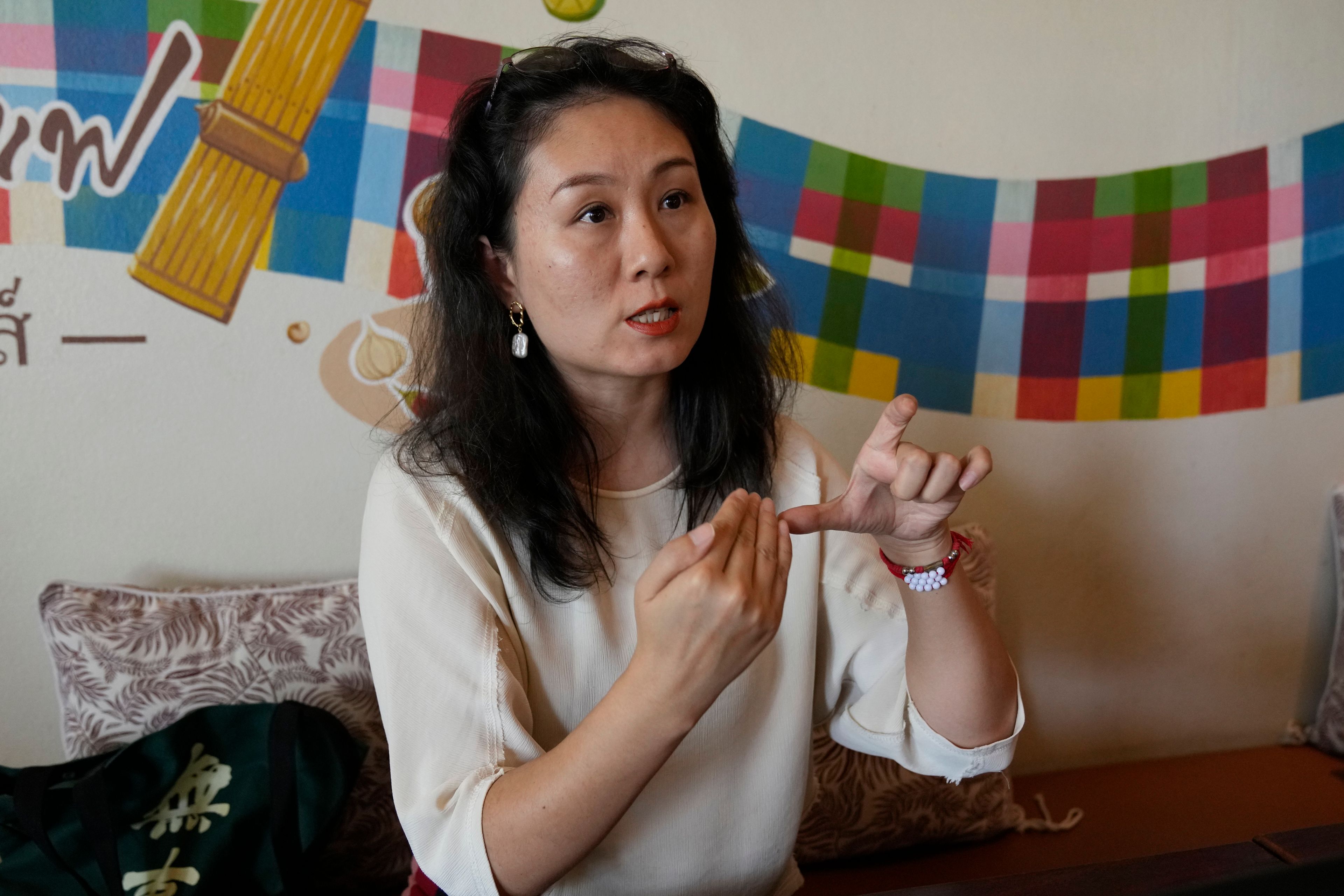 Chinese mother Du Xuan gestures during an interview with The Associated Press in Chiang Mai province, Thailand, Tuesday, April 23, 2024.