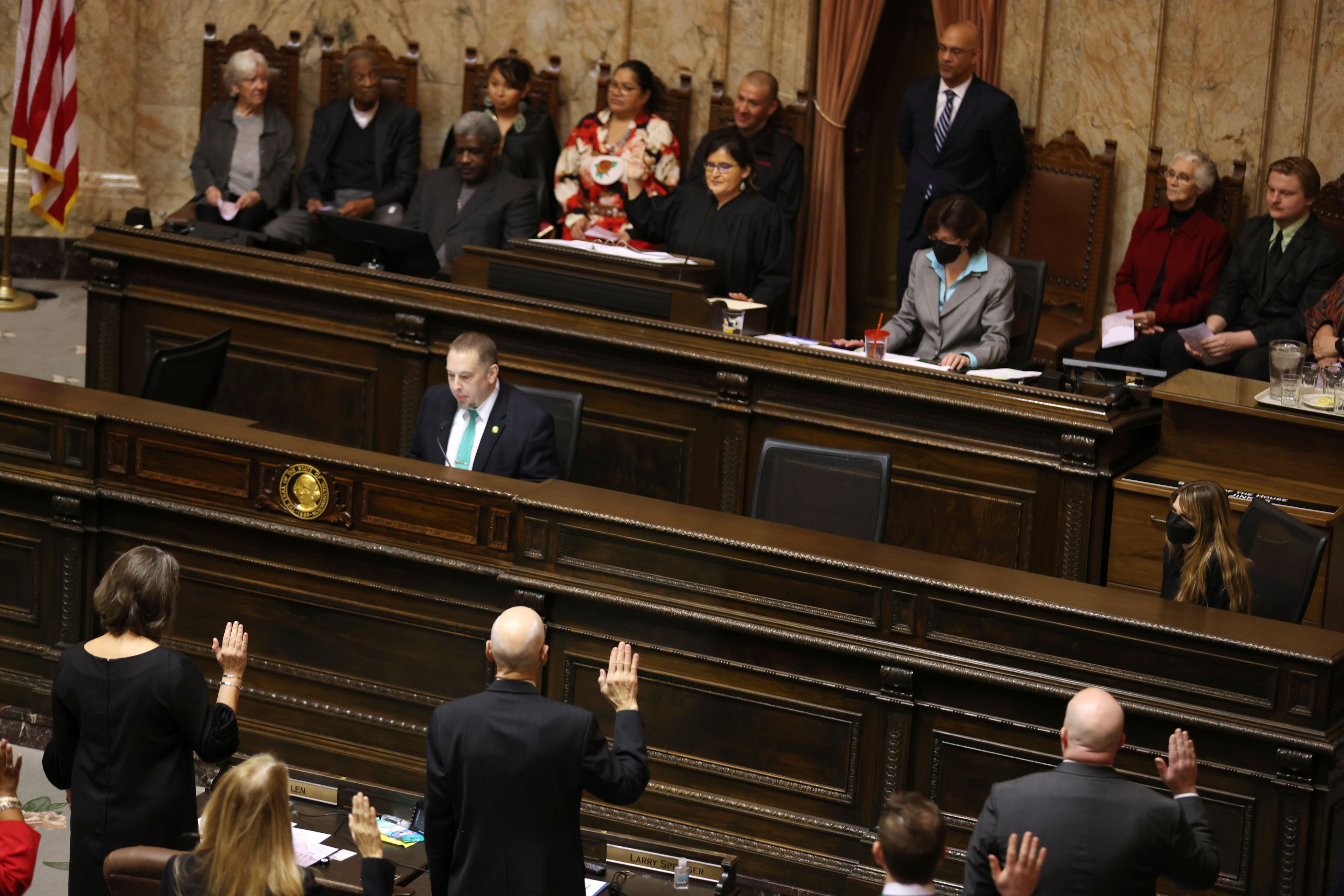 Legislators swear in on the first day of the legislative session at the Washington state Capitol in Olympia, Wash., on Monday, Jan. 9, 2023. (Karen Ducey/The Seattle Times via AP)