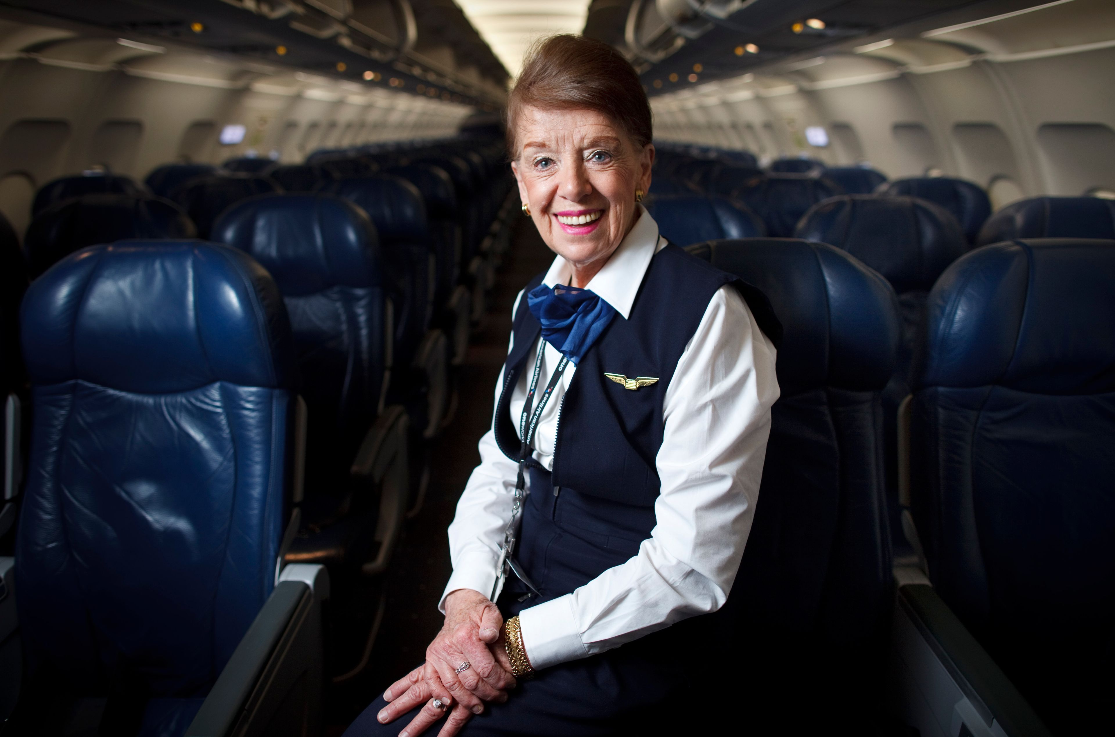 FILE - Flight attendant Bette Nash poses on a plane at Logan International Airport in Boston on Dec. 18, 2014. Nash, who was once named the world's longest-serving flight attendant, has died. She was 88. American Airlines, Nash's employer, announced her passing on social media Saturday.