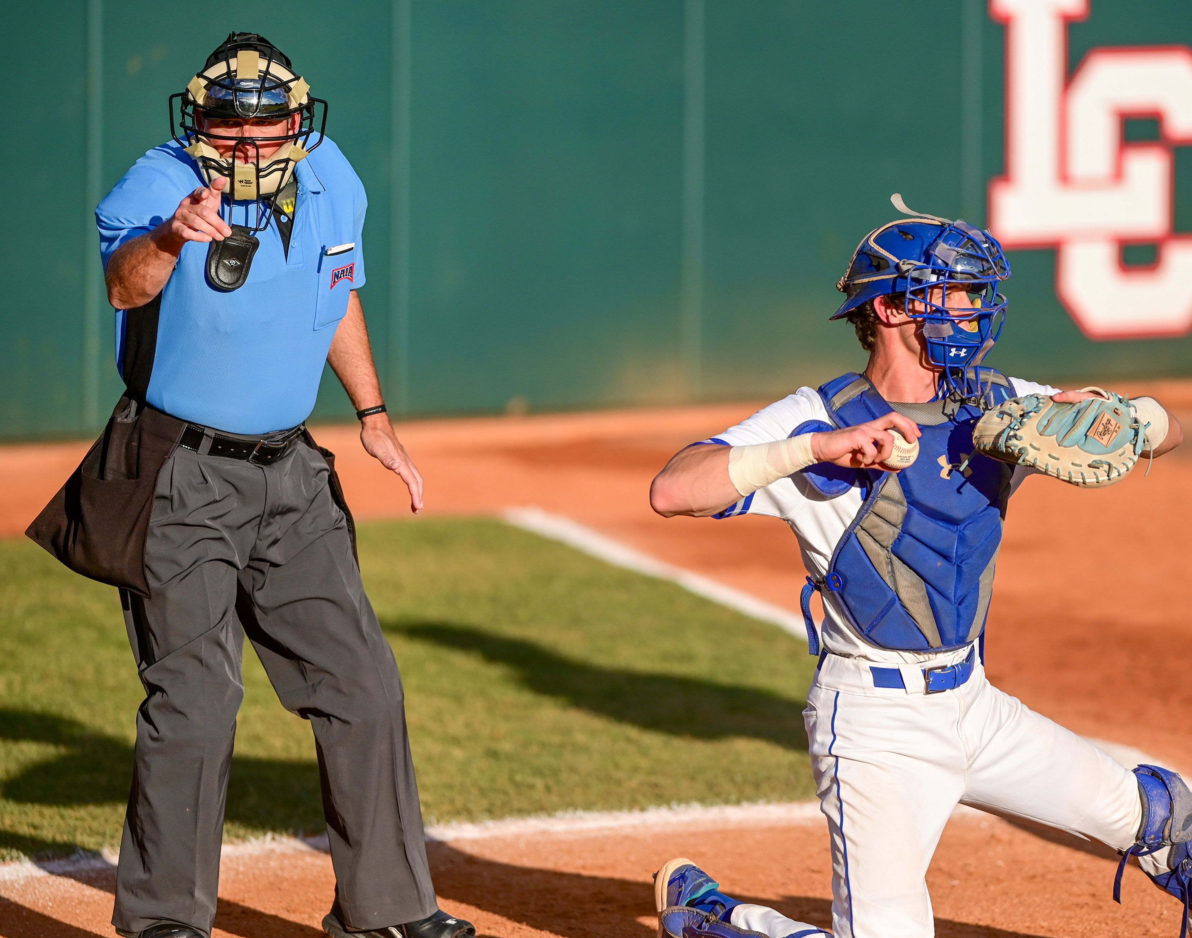 An umpire calls a strike against Reinhardt as Tennessee Wesleyan’s catcher Daniel Stewart throws the ball back to the pitcher in Game 18 of the NAIA World Series at Harris Field in Lewiston on Thursday.