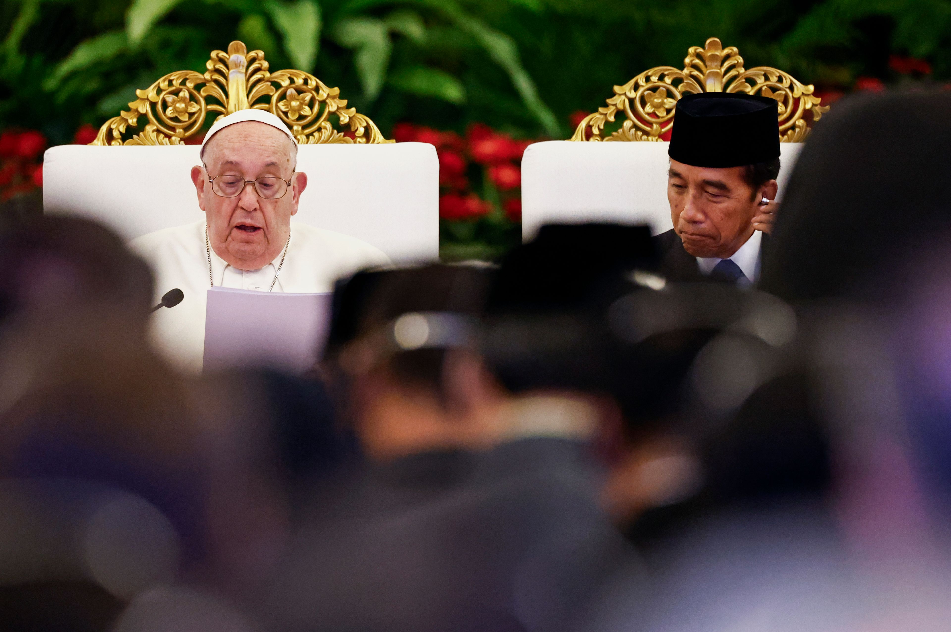 Pope Francis, left, delivers his address as Indonesian President Joko Widodo listens during a meeting with Indonesian authorities, civil society and the diplomatic corps, during his apostolic visit to Asia, at the Presidential Palace in Jakarta Wednesday, Sept. 4, 2024.