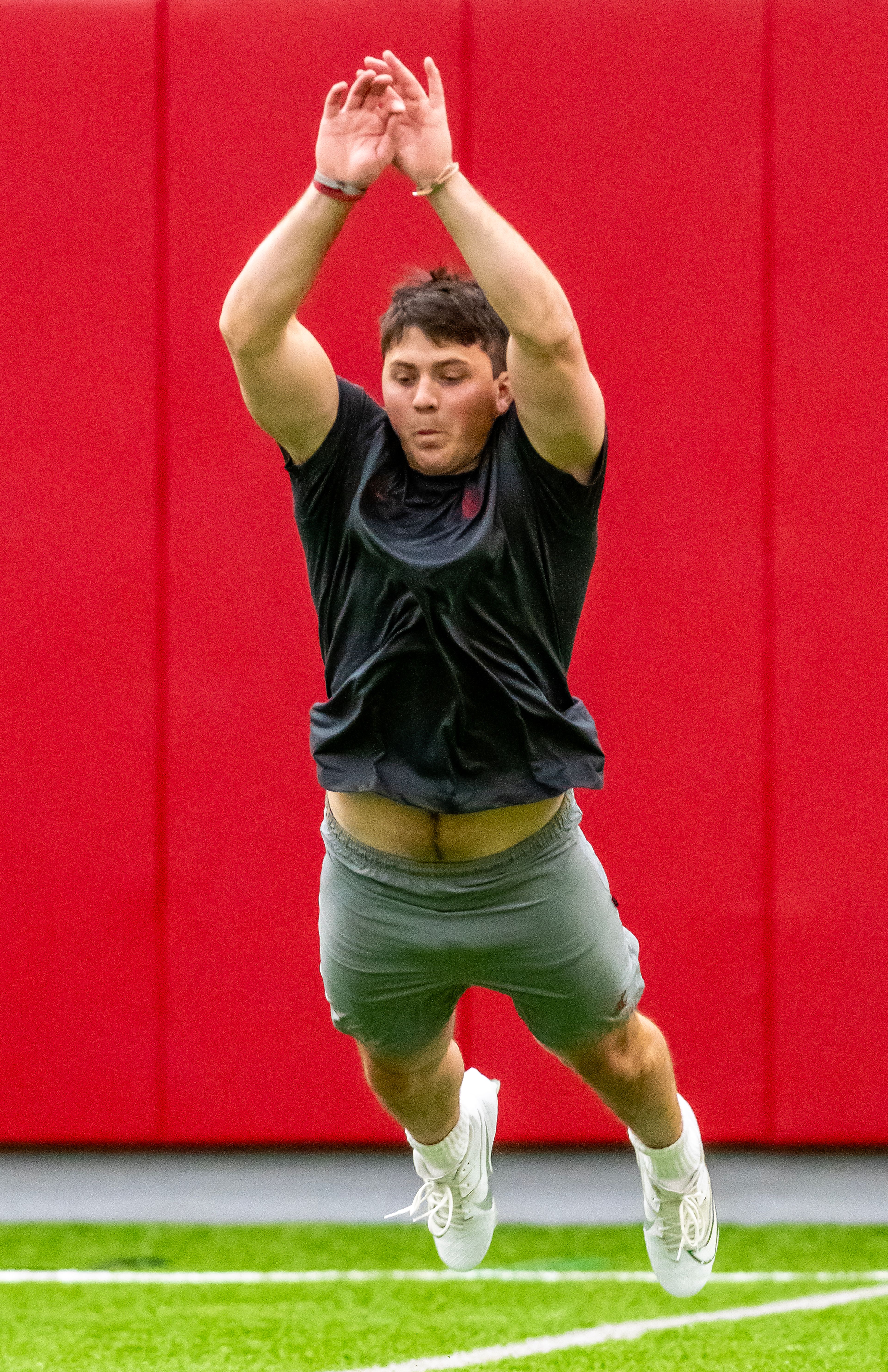 Washington State tight end Cooper Mathers leaps forward in the broad jump test during WSU's Pro Day on Friday in Pullman.