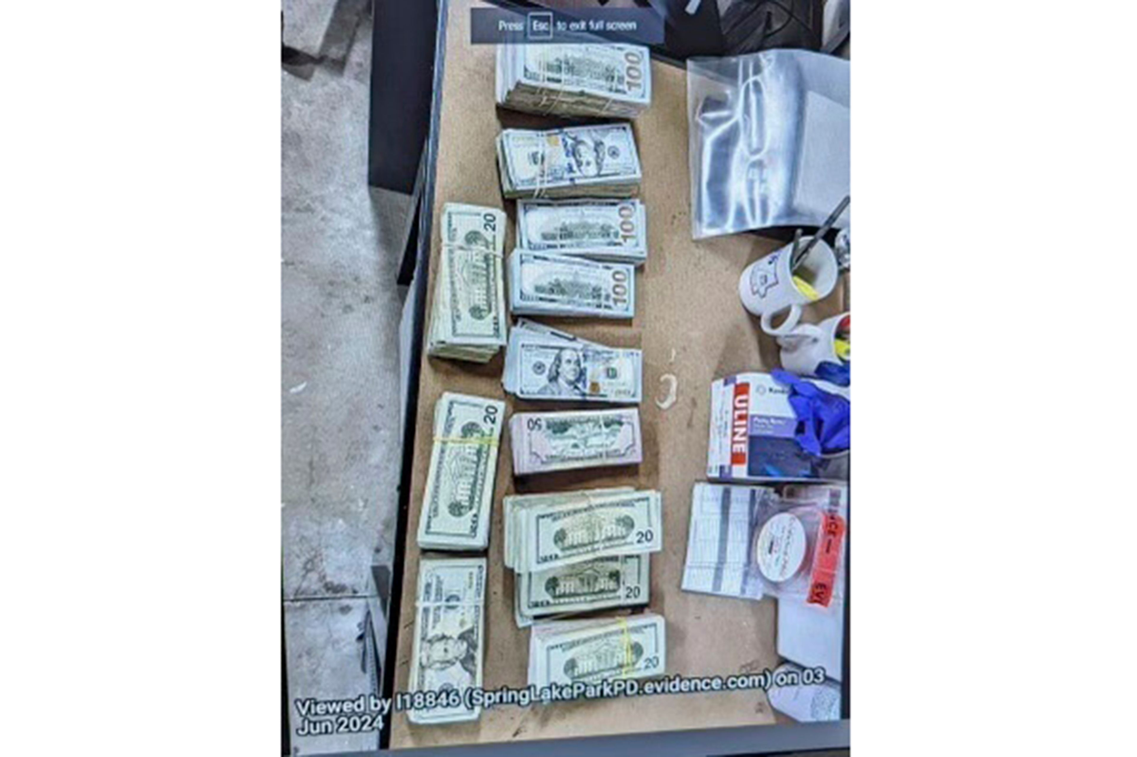 This photo supplied by the U.S. Attorney's Office for Minnesota shows cash from a bag that was left at the home of a juror in a massive fraud case, June 2, 2024, outside Minneapolis, Minn. Authorities have confiscated cellphones and taken all seven defendants into custody as investigators try to determine who attempted to bribe the juror to acquit them on charges of stealing more than $40 million from a program meant to feed children during the pandemic.