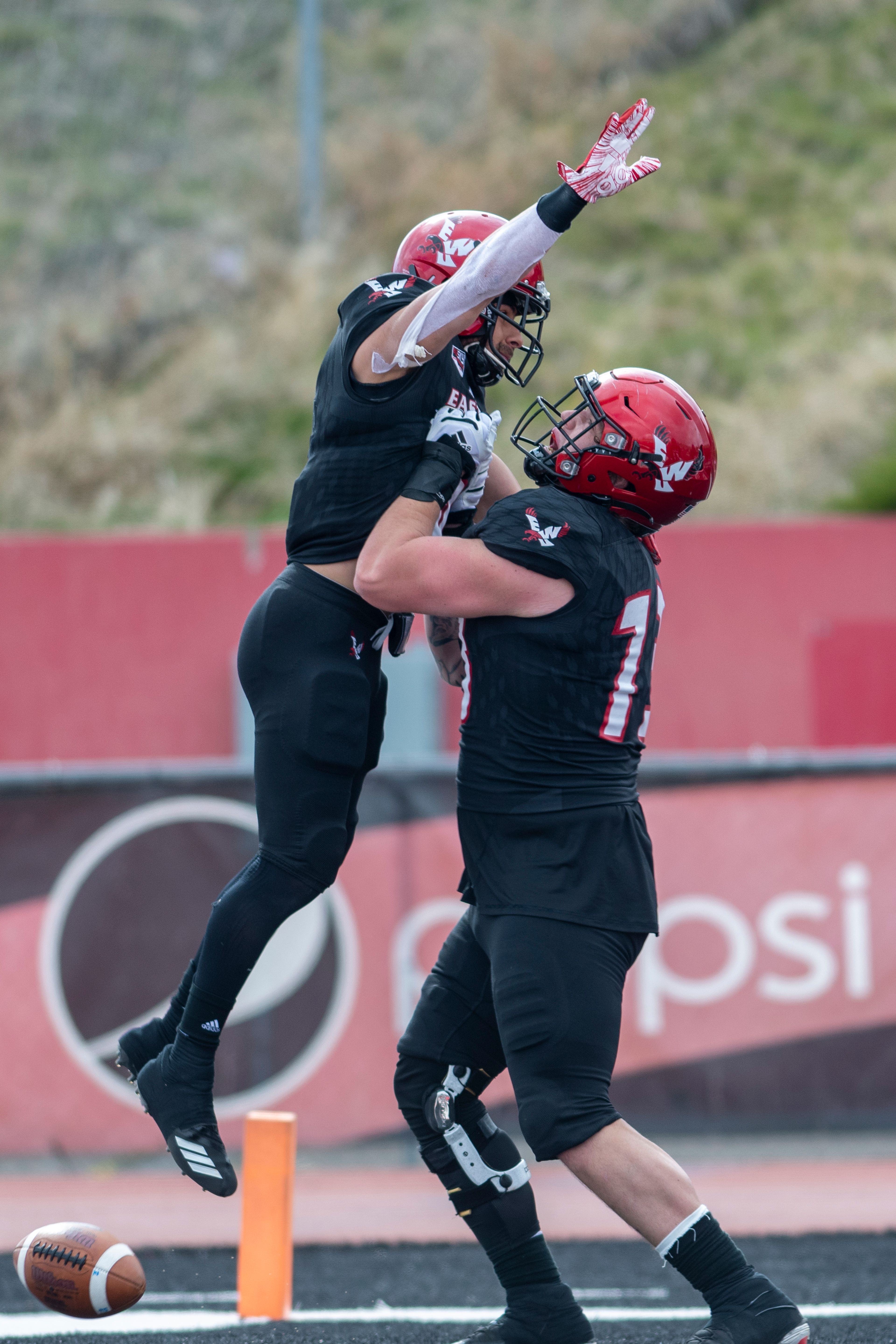 Eastern Washington running back Dennis Merritt (6) celebrates with offensive lineman Matt Shook (73) after scoring a touchdown during the third quarter of a Big Sky Conference matchup at Roos Field on Saturday afternoon. Eastern Washington defeated Idaho 38-31.