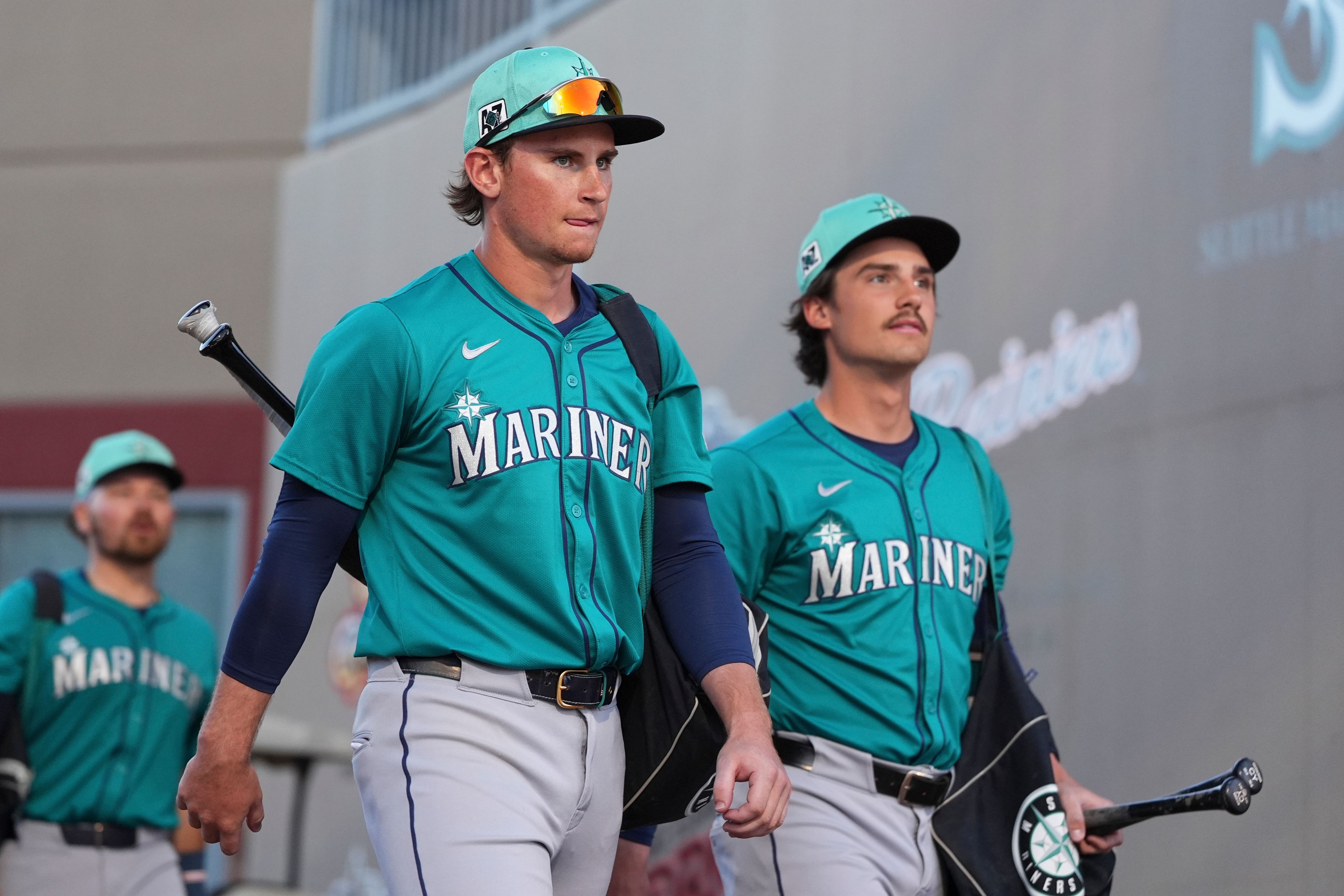 FILE - Seattle Mariners shortstop Colt Emerson, left, arrives with Cole Young, right, for a spring training baseball game against the San Diego Padres, Feb. 28, 2025, in Peoria, Ariz. (AP Photo/Lindsey Wasson, File)