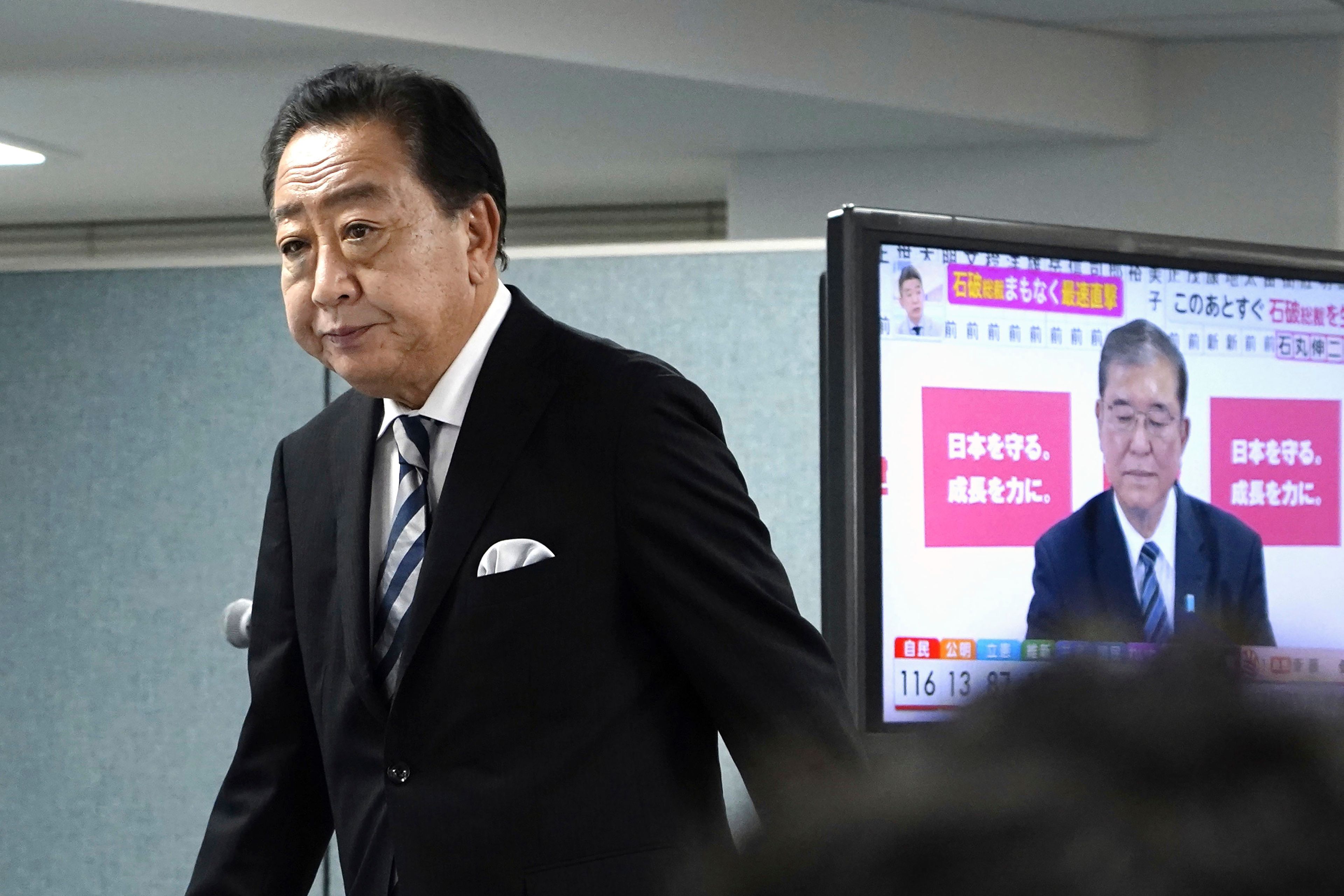 Yoshihiko Noda, leader of Japan's opposition Constitutional Democratic Party, prepares for a media interview with Japan's Prime Minister and president of the Liberal Democratic Party (LDP) Shigeru Ishiba seen on TV screen, at Nodaâ€™s party headquarters Sunday, Oct. 27, 2024 in Tokyo, (Kyodo News via AP)