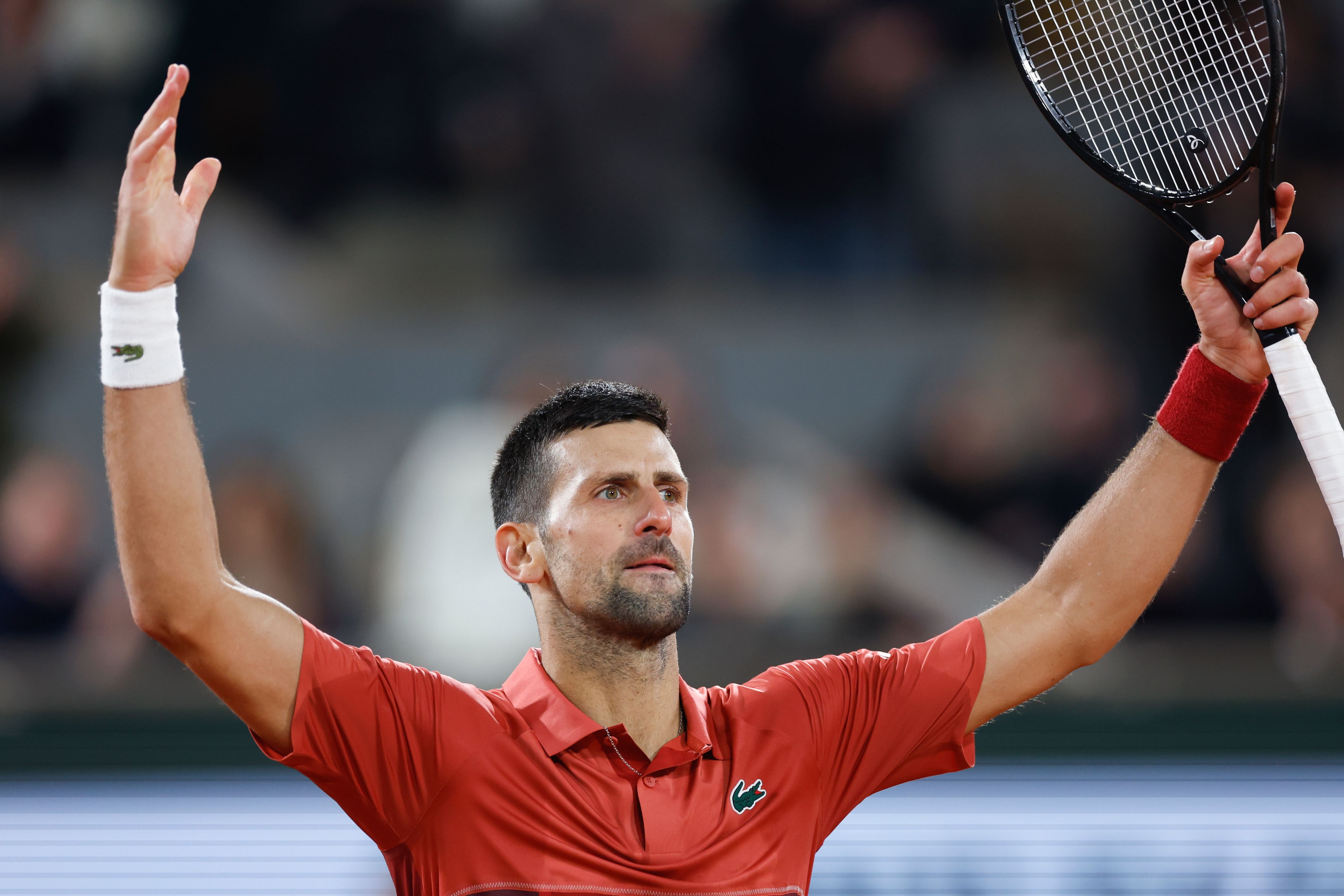 FILE - Serbia's Novak Djokovic plays the crowd during his third round match of the French Open tennis tournament against Italy's Lorenzo Musetti at the Roland Garros stadium in Paris, Sunday, June 2, 2024. Novak Djokovic withdrew from the French Open with an injured right knee on Tuesday, June 4, 2024, ending his title defense and meaning he will relinquish the No. 1 ranking.