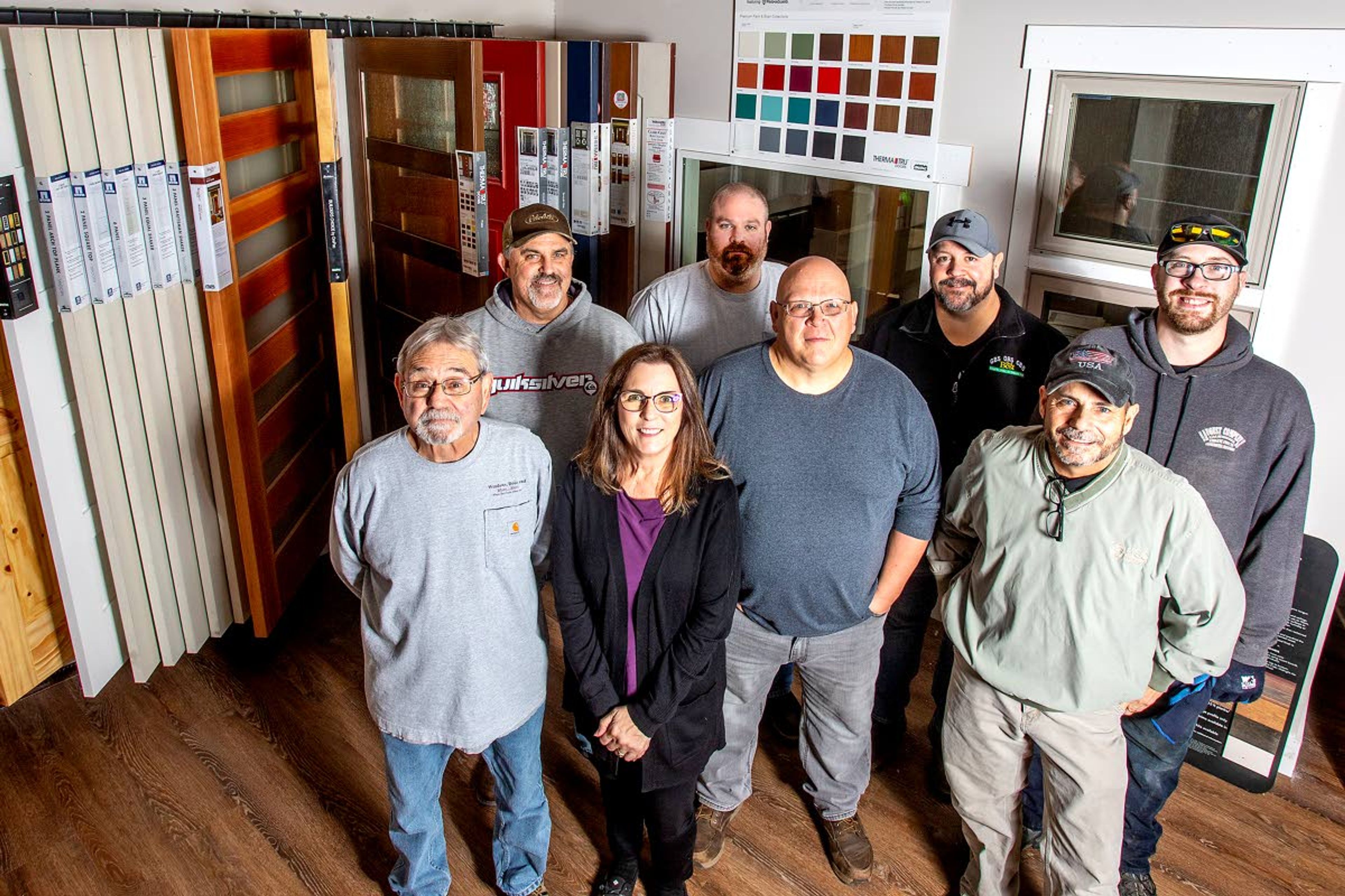 From left: Mike Seale, Mike Millar, Melodie Earle, Josh Reasoner, Harold Kerley, Mike Forrest, Tony Teel and Ben Johnston gather for a photo Monday inside the new location of Windows Doors and More in Lewiston.