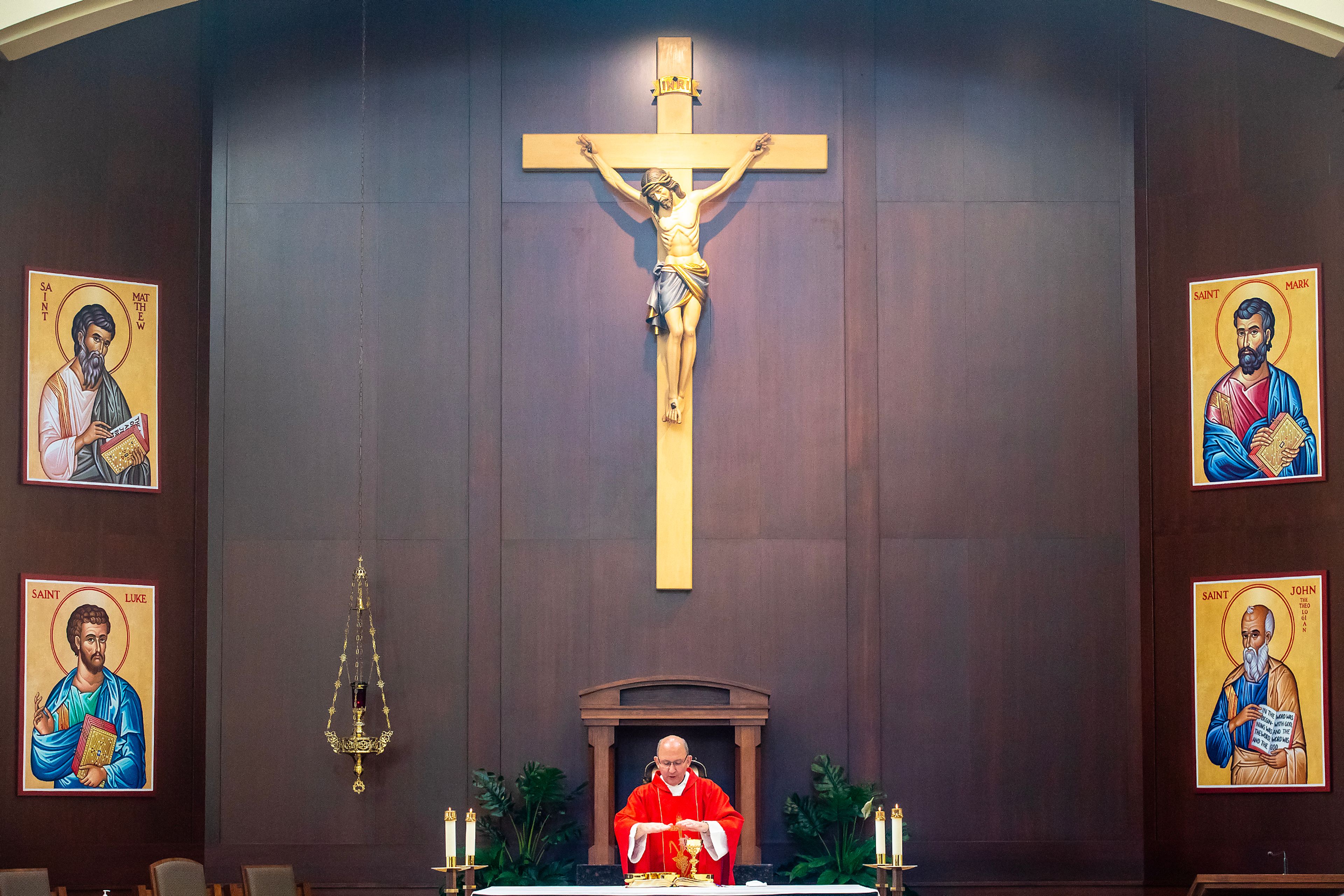 The Rev. Mike St. Marie consecrates bred and wine during Mass on Wednesday at All Saints Catholic Church in the Lewiston Orchards.