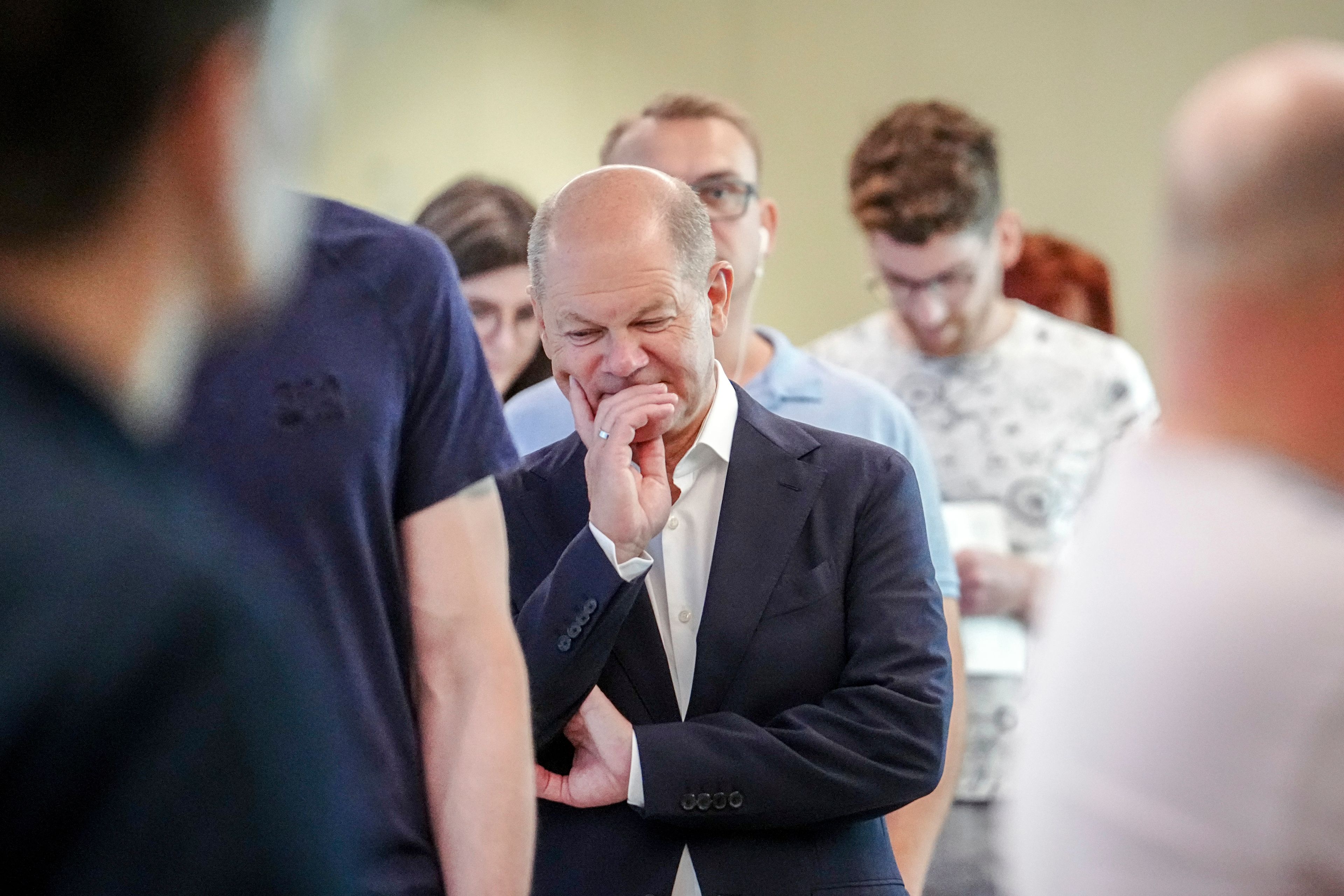 German Chancellor Olaf Scholz waits in line to cast his vote for the European Parliament elections, in Potsdam, Germany, Sunday, June 9, 2024. Tens of millions across the European Union were voting in EU parliamentary elections on Sunday in a massive exercise of democracy that is expected to shift the bloc to the right and redirect its future.