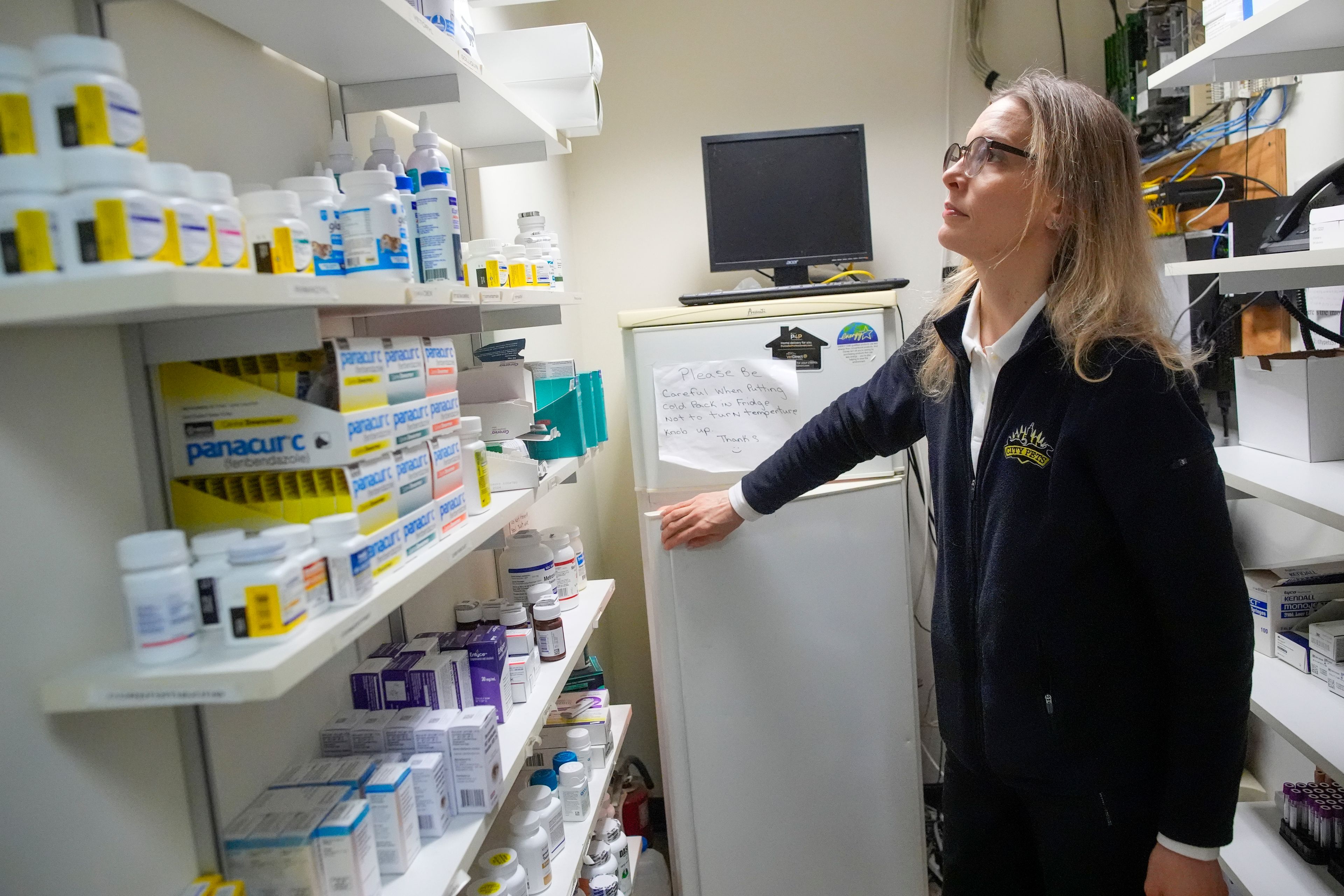 Licensed veterinary technician Jeanine Lunz looks over medical supplies at the City Pets office before leaving for a house call with Dr. Amy Attas, Tuesday, April 23, 2024, in New York.