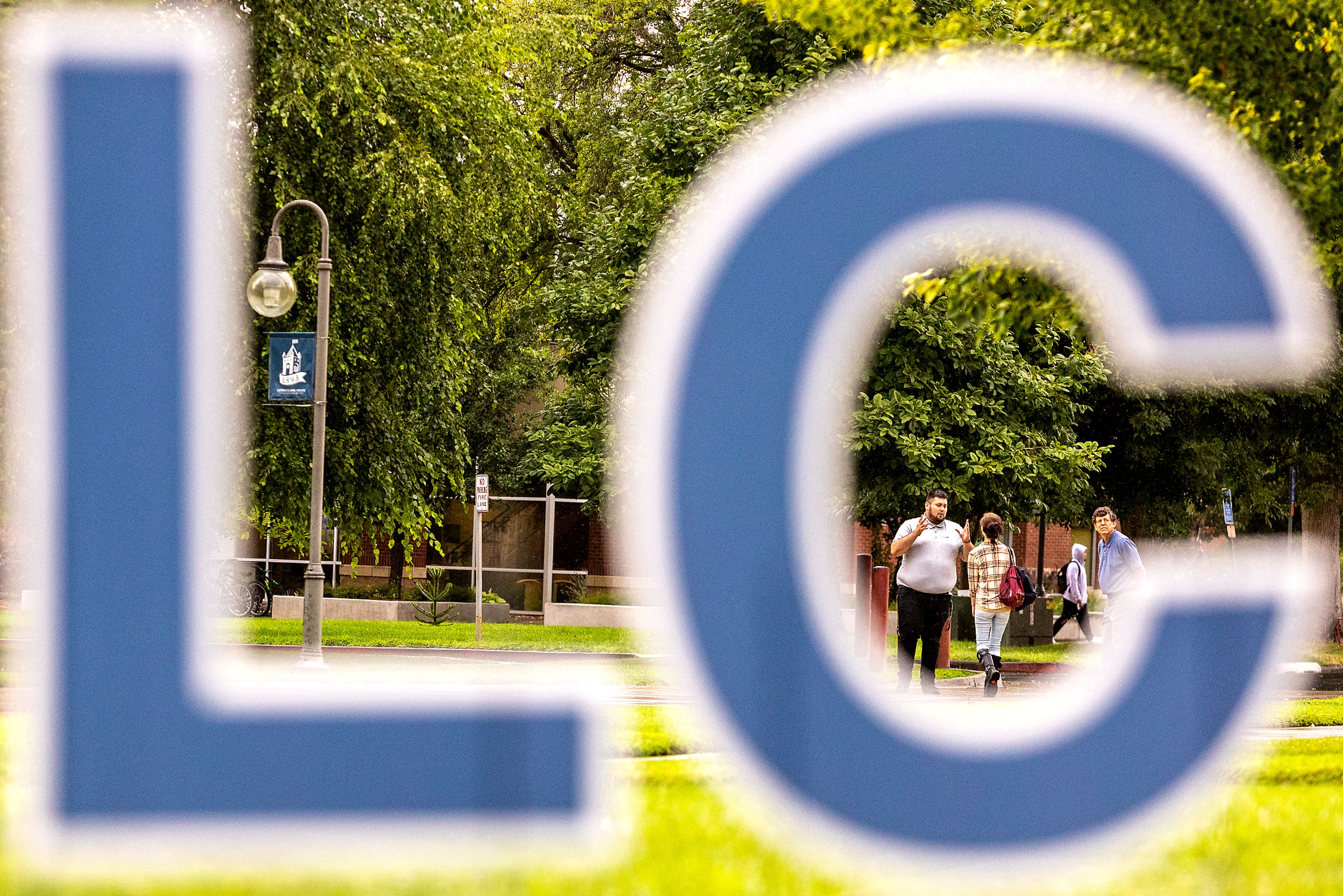 People walk through campus framed in cutouts spelling out “LC State” on the first day of classes at Lewis-Clark State College on Monday in Lewiston.