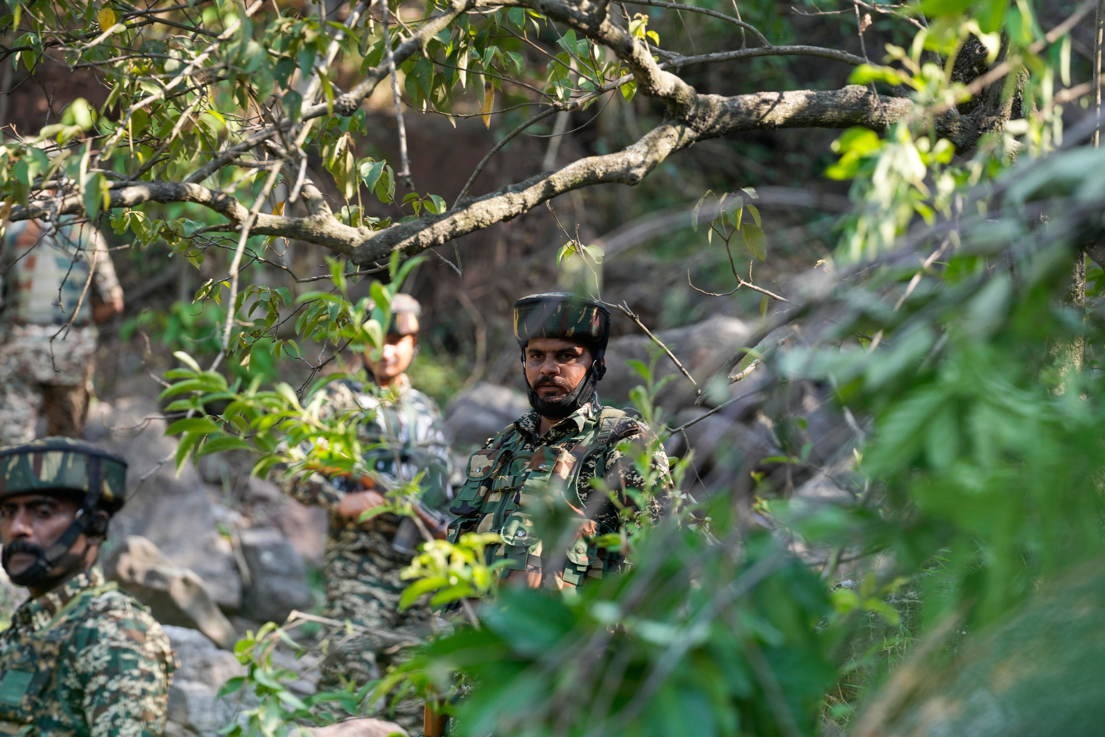 Indian army soldiers patrol the area where a bus fell into a deep gorge on Sunday after being fired at by suspected militants in Reasi district, Jammu and Kashmir, Monday, June 10, 2024. The bus was carrying pilgrims to the base camp of the famed Hindu temple Mata Vaishno Devi when it came under attack killing at least nine people.