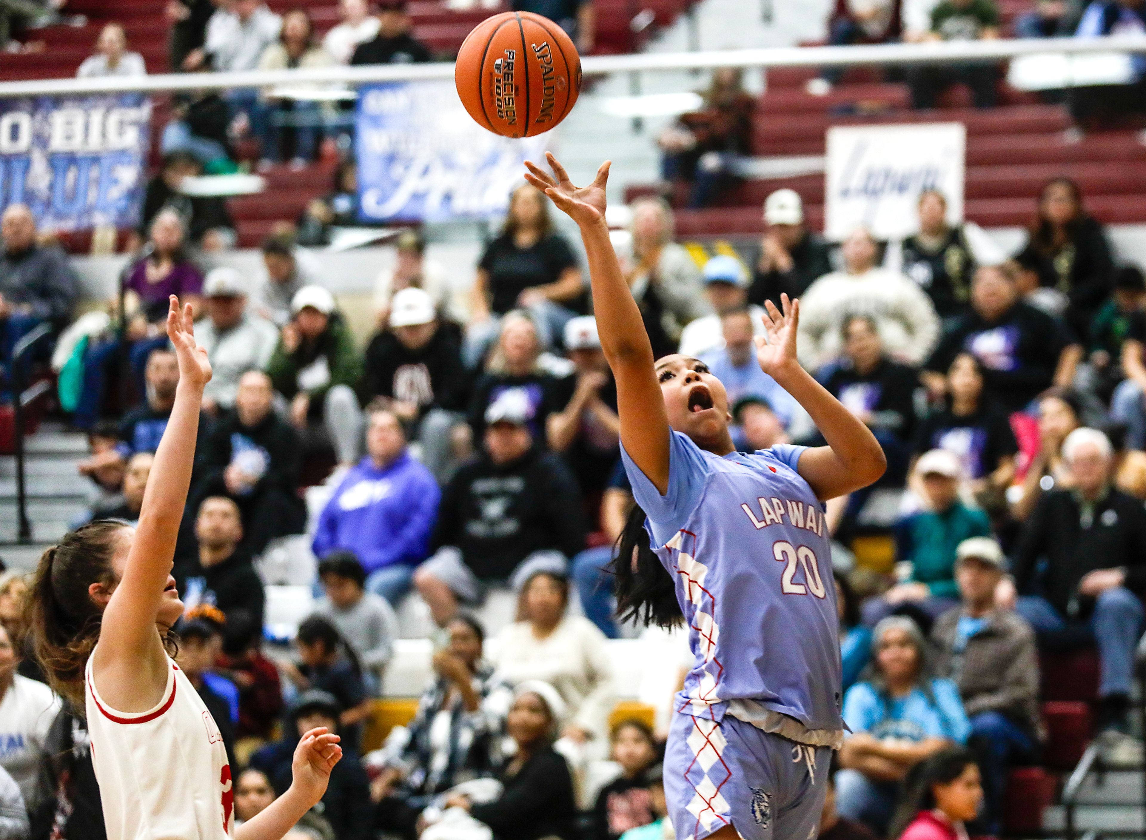 Lapwai's Lois Oatman shoots a layup as Oakley forward Chloe Berlin guards her during an Idaho Class 1A DI girls state semifinal game Friday at Columbia High School.