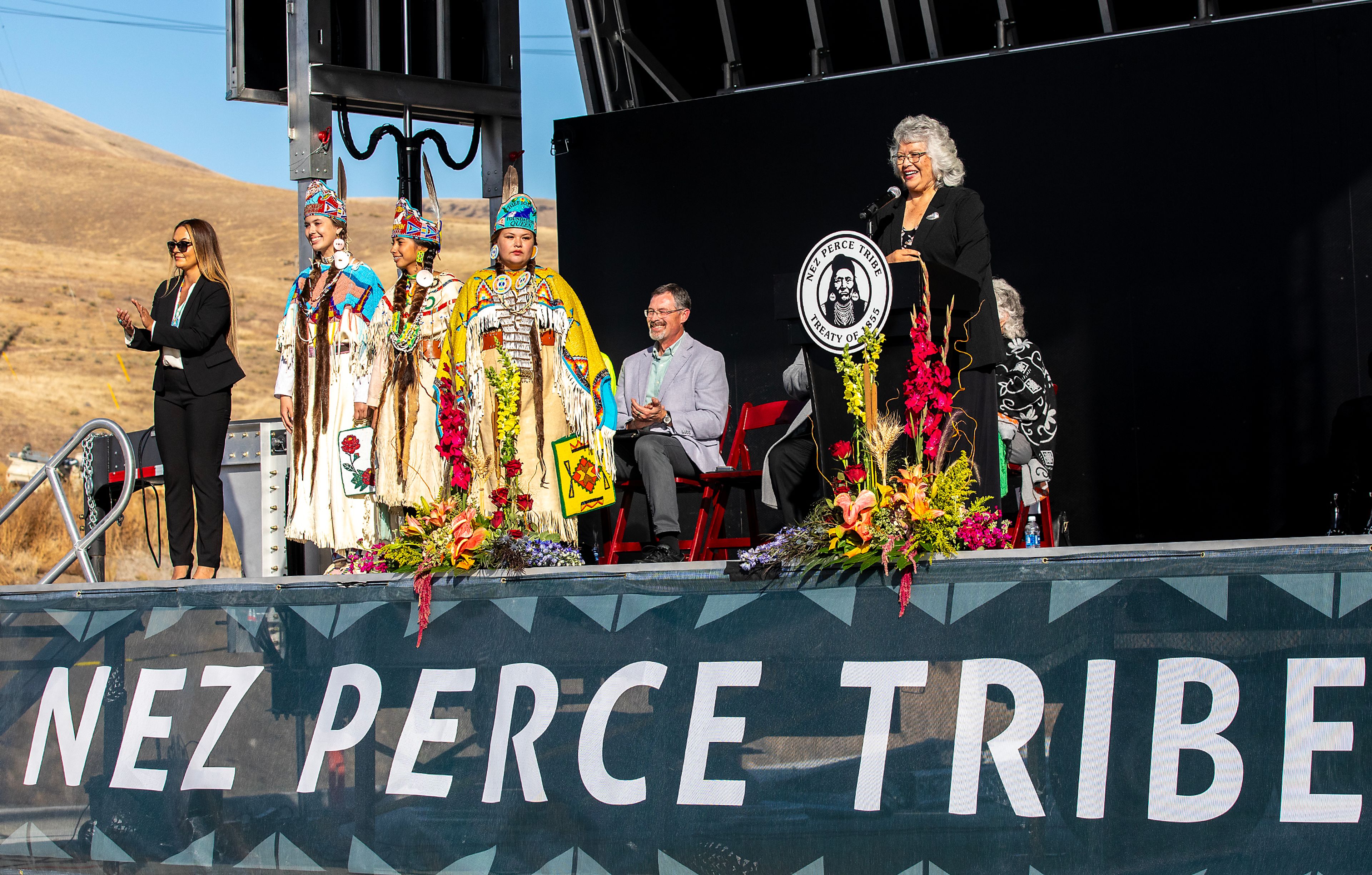 Stacia Morin, from left, members of the Nimiipuu Riders and Mary Beth Clark stand on stage Thursday at the ribbon cutting ceremony for the Aht�Wy Interchange over U.S. Highway 95/12 in Lewiston.