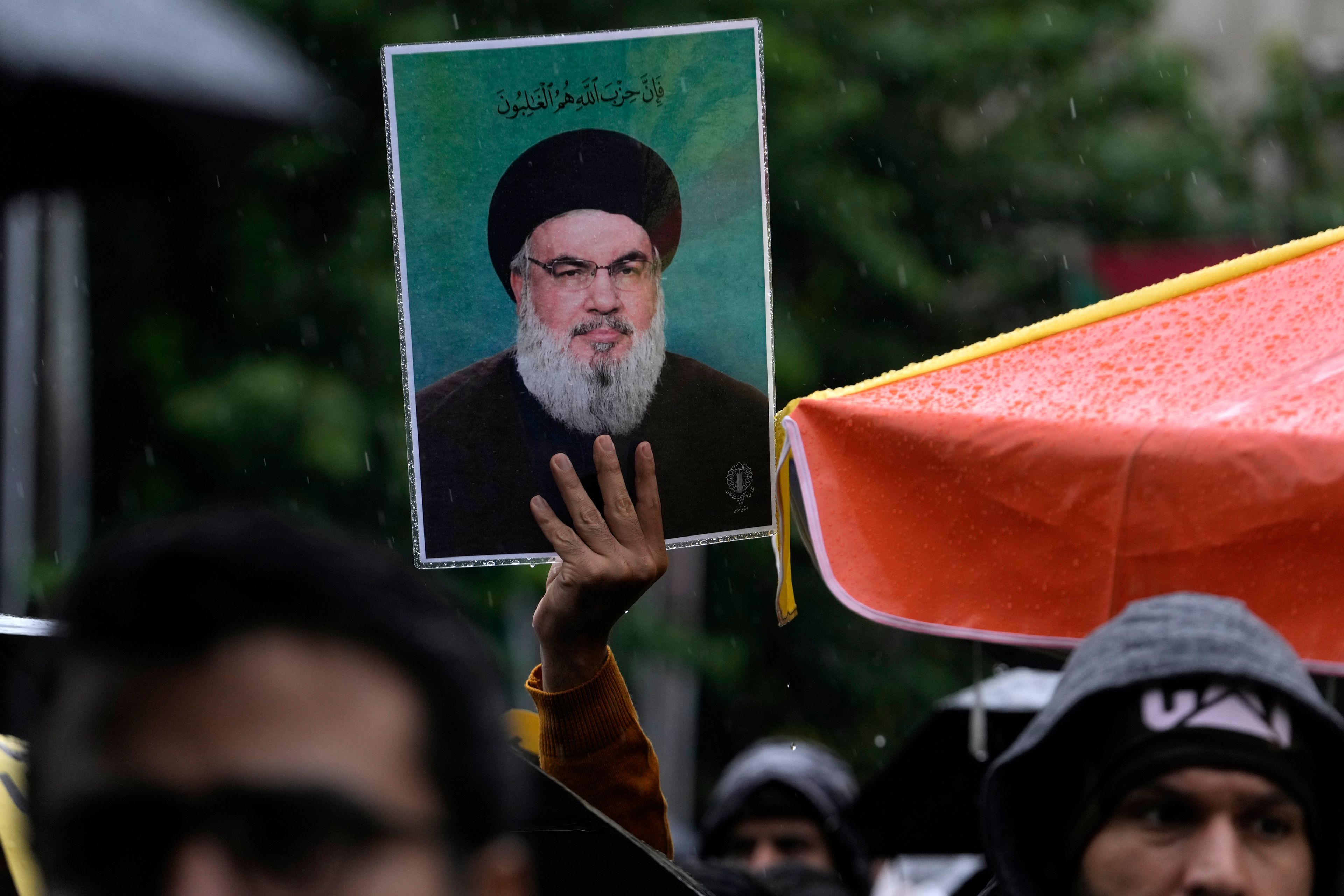 An Iranian demonstrator holds up a poster of the leader of Lebanon's militant Hezbollah group Hassan Nasrallah in a gathering to support Hezbollah at the Felestin (Palestine) Square in downtown Tehran, Iran, Saturday, Sept. 28, 2024. (AP Photo/Vahid Salemi)