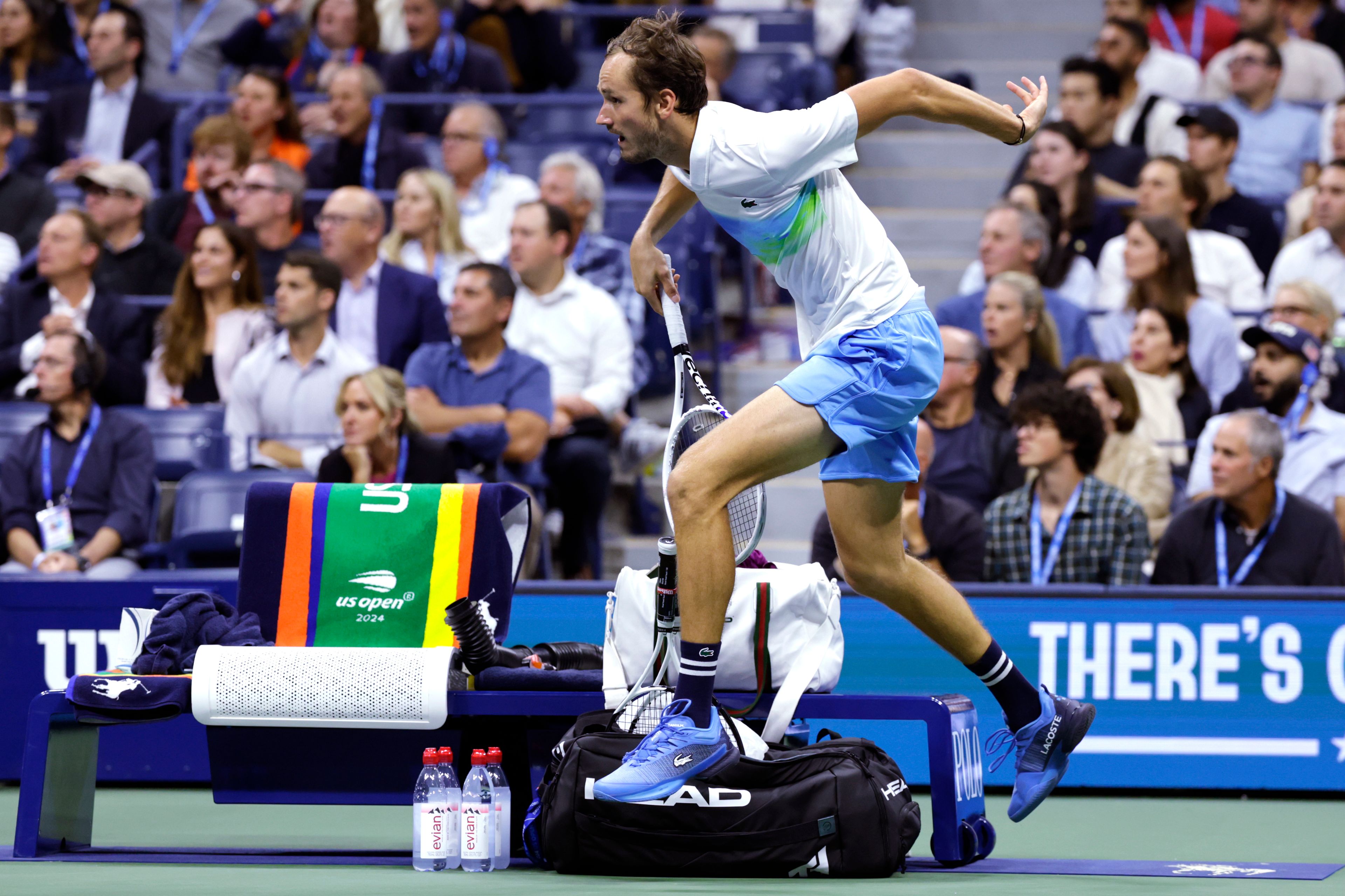 Daniil Medvedev, of Russia, leaps over the player's bench on a return against Jannik Sinner, of Italy, during the quarterfinals of the U.S. Open tennis championships, Wednesday, Sept. 4, 2024, in New York.