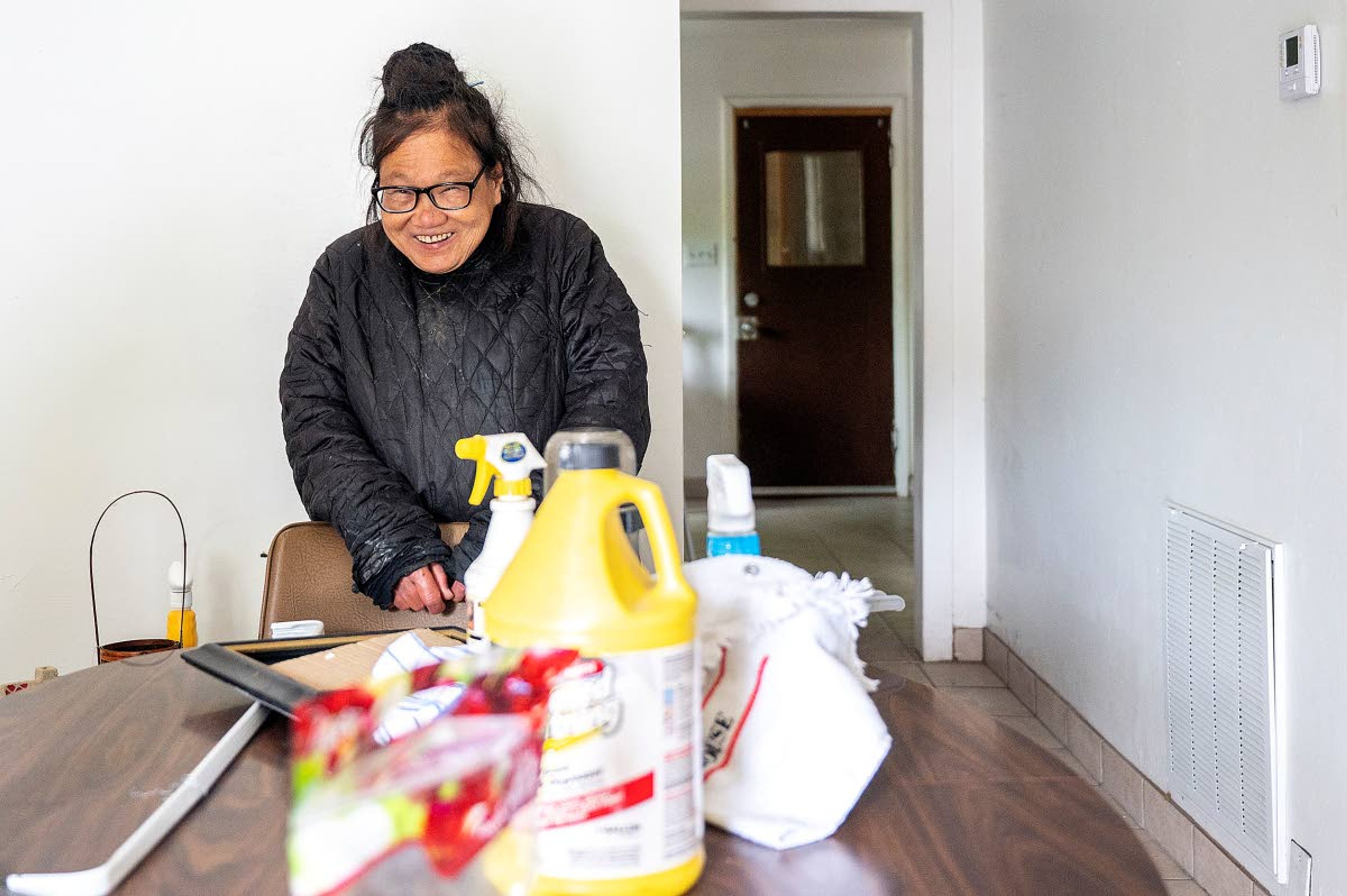 Helen Wong keeps a smile on her face while a crew of several kind-hearted volunteers work on deep cleaning her home in Lewiston.