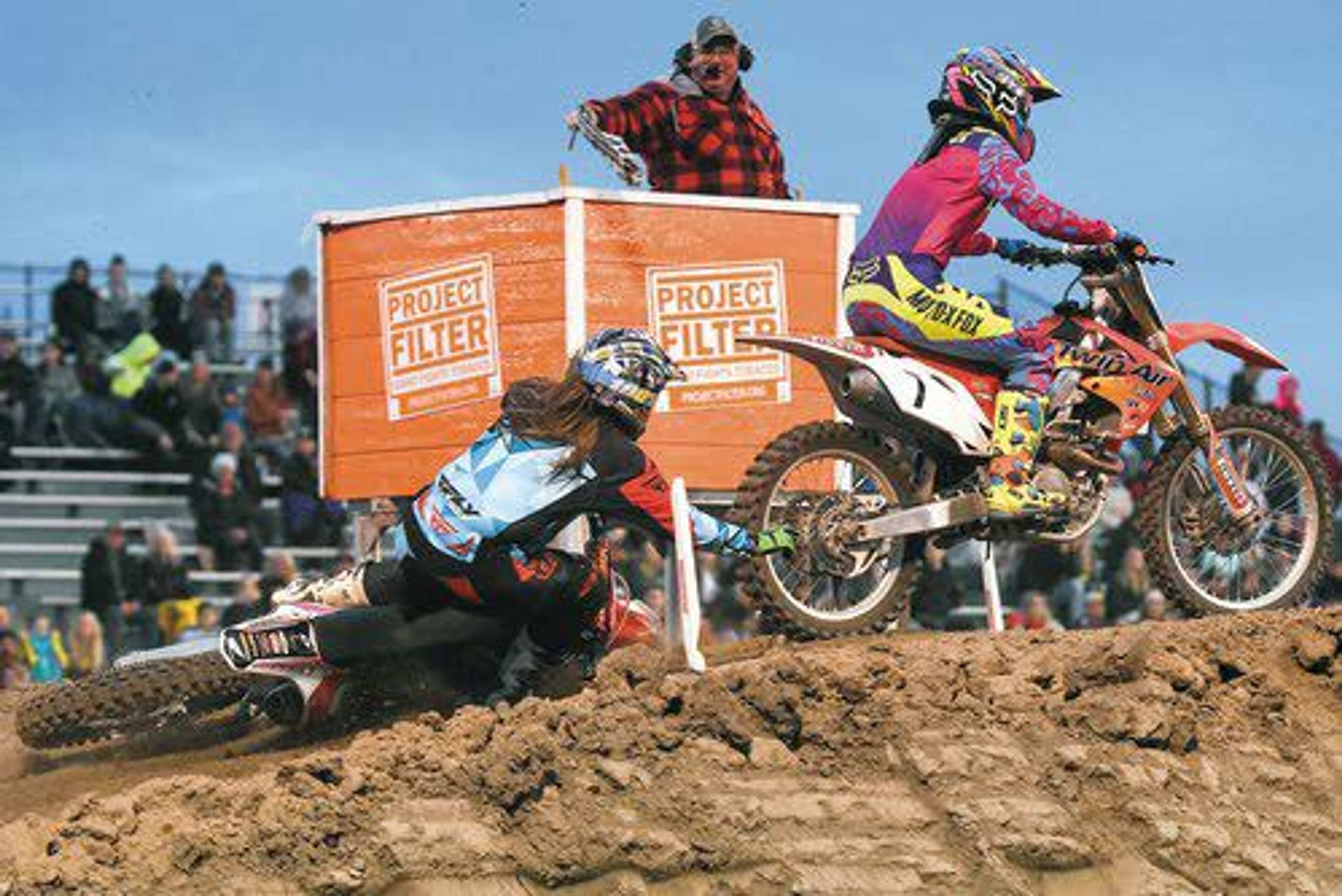 Renee Jenkins, of Lewiston, right, wins the women's race as Chelbee Pace, of Lewiston, crashes at the finish line during the women's race on Saturday night at the Lewiston Supercross event at the Lewiston Roundup Grounds.