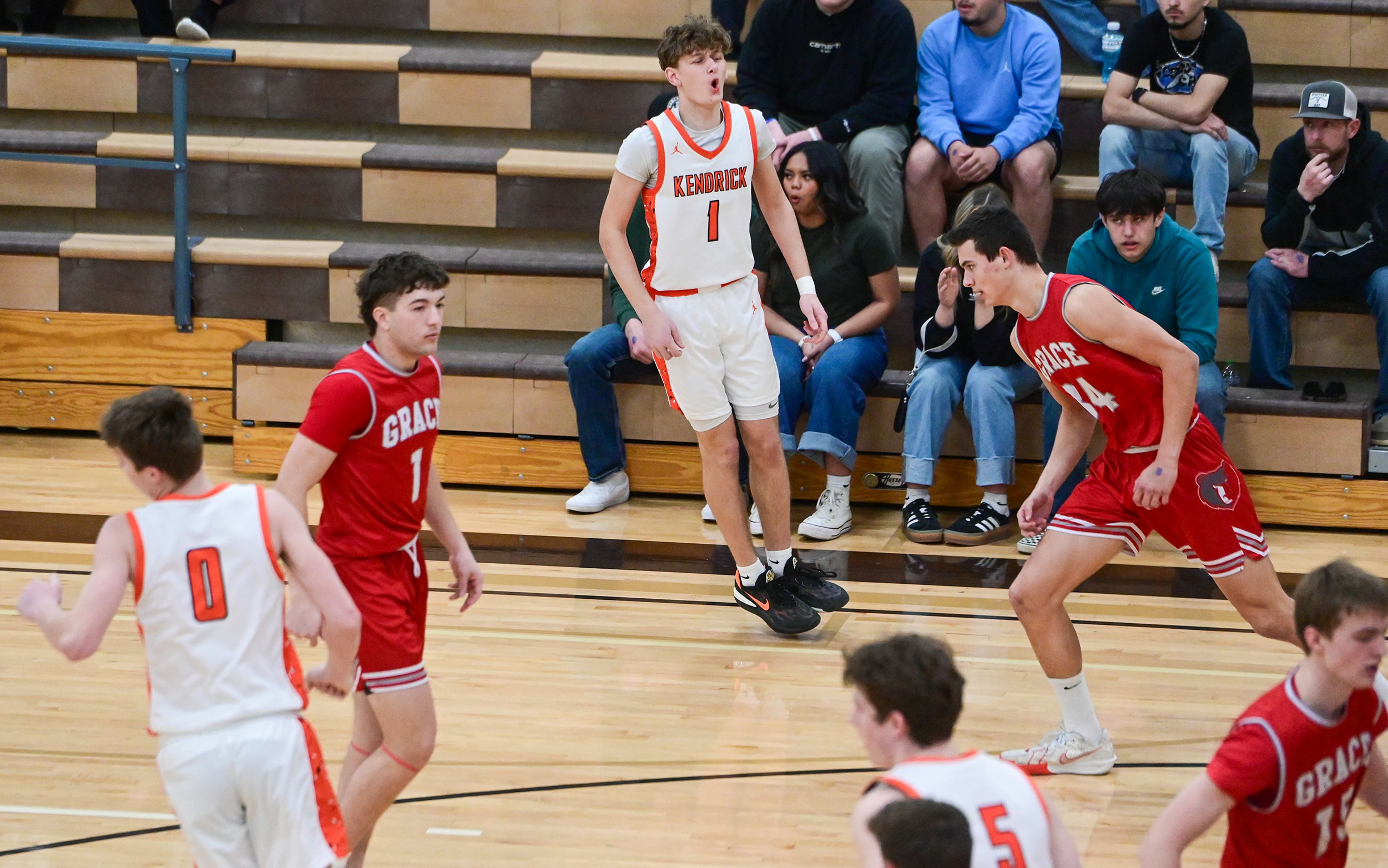 Kendrick's Cade Silflow, center, celebrates his three-point shot against Grace at the Idaho 2A state tournament on Friday in Caldwell, Idaho.