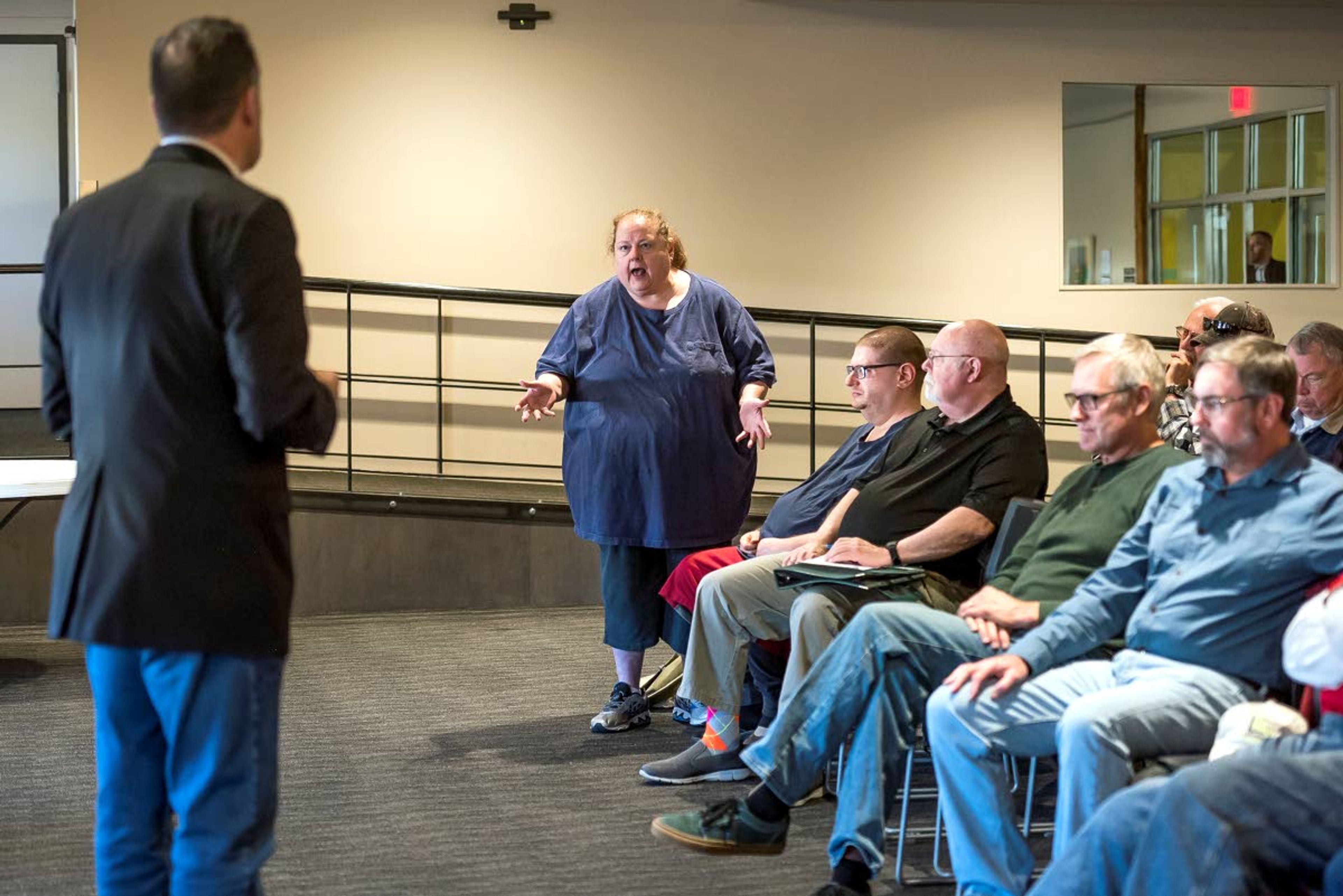 Lewiston's Marla Barnes (center) asks Rep. Russ Fulcher (left) a question during a town hall meeting at the Lewiston City Library on Friday in Lewiston.