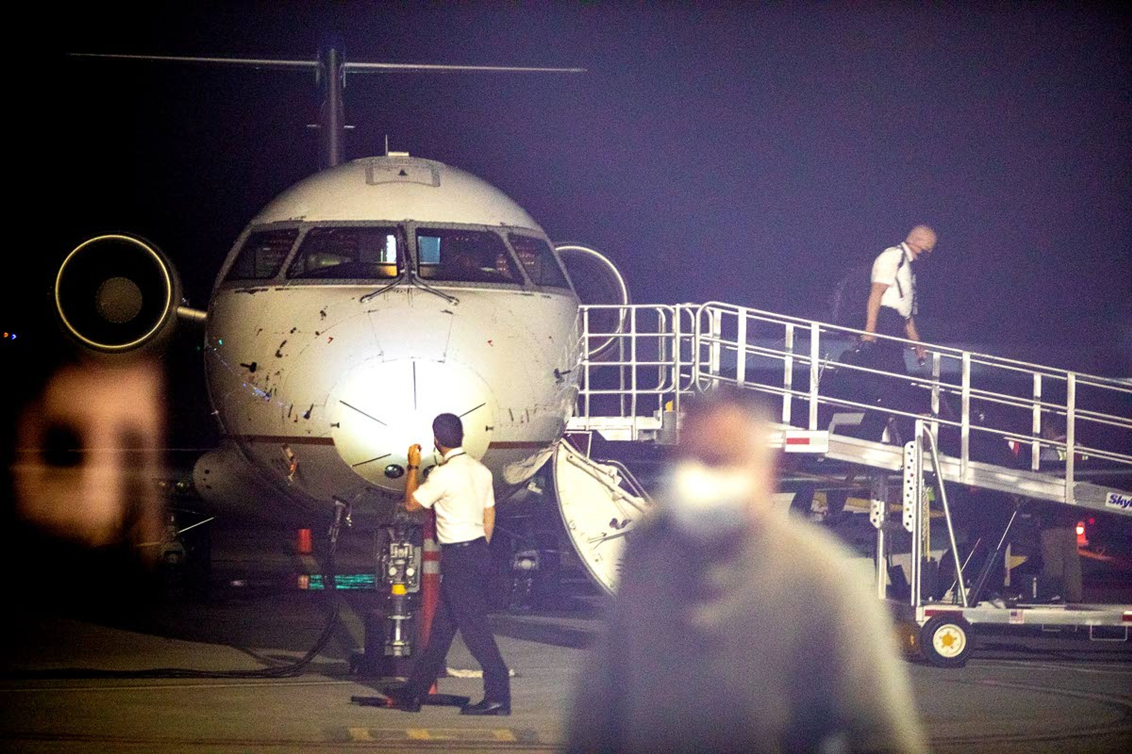 Pilots disembark the United Airlines plane as passengers head into the terminal Tuesday evening at the Lewiston-Nez Perce County Regional Airport.