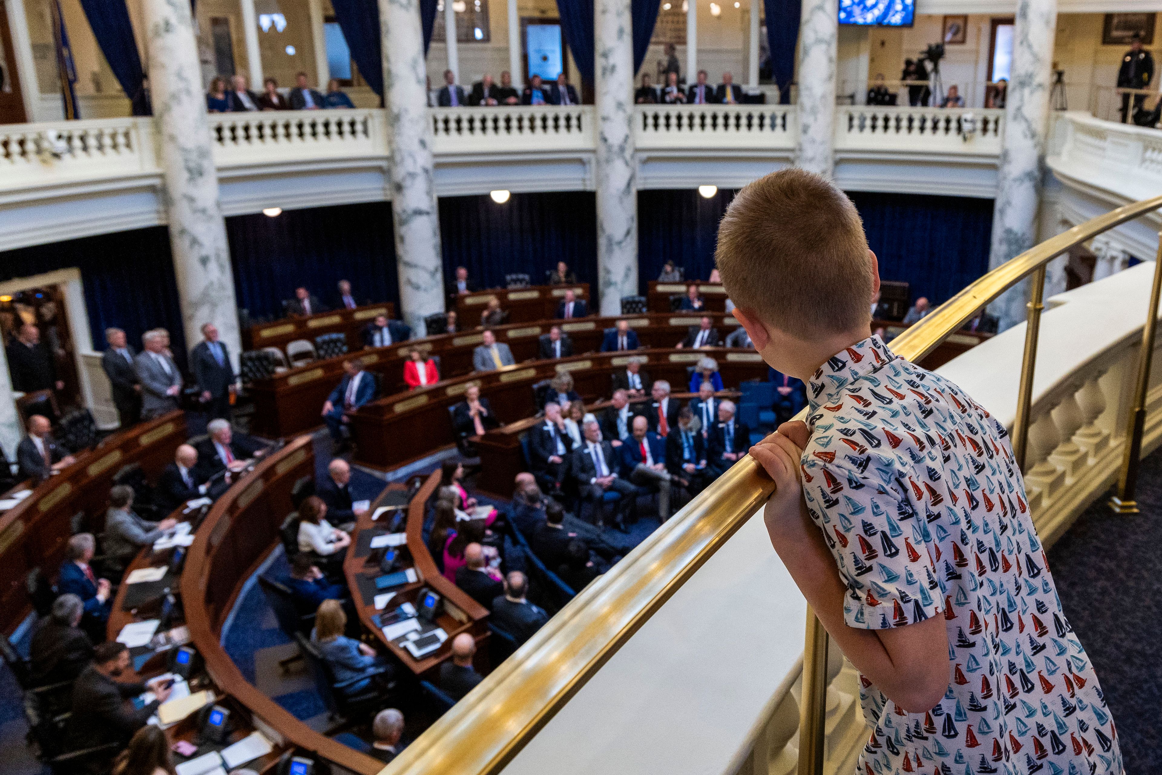 Temple Toews, 9, Coeur d'Alene, peeks over the gallery handrail to watch the proceedings leading up to Gov. Brad Little's 2024 State of the State address to the Idaho Legislature, Monday, Jan. 8, 2024, at the Statehouse in Boise. (Darin Oswald/Idaho Statesman via AP)