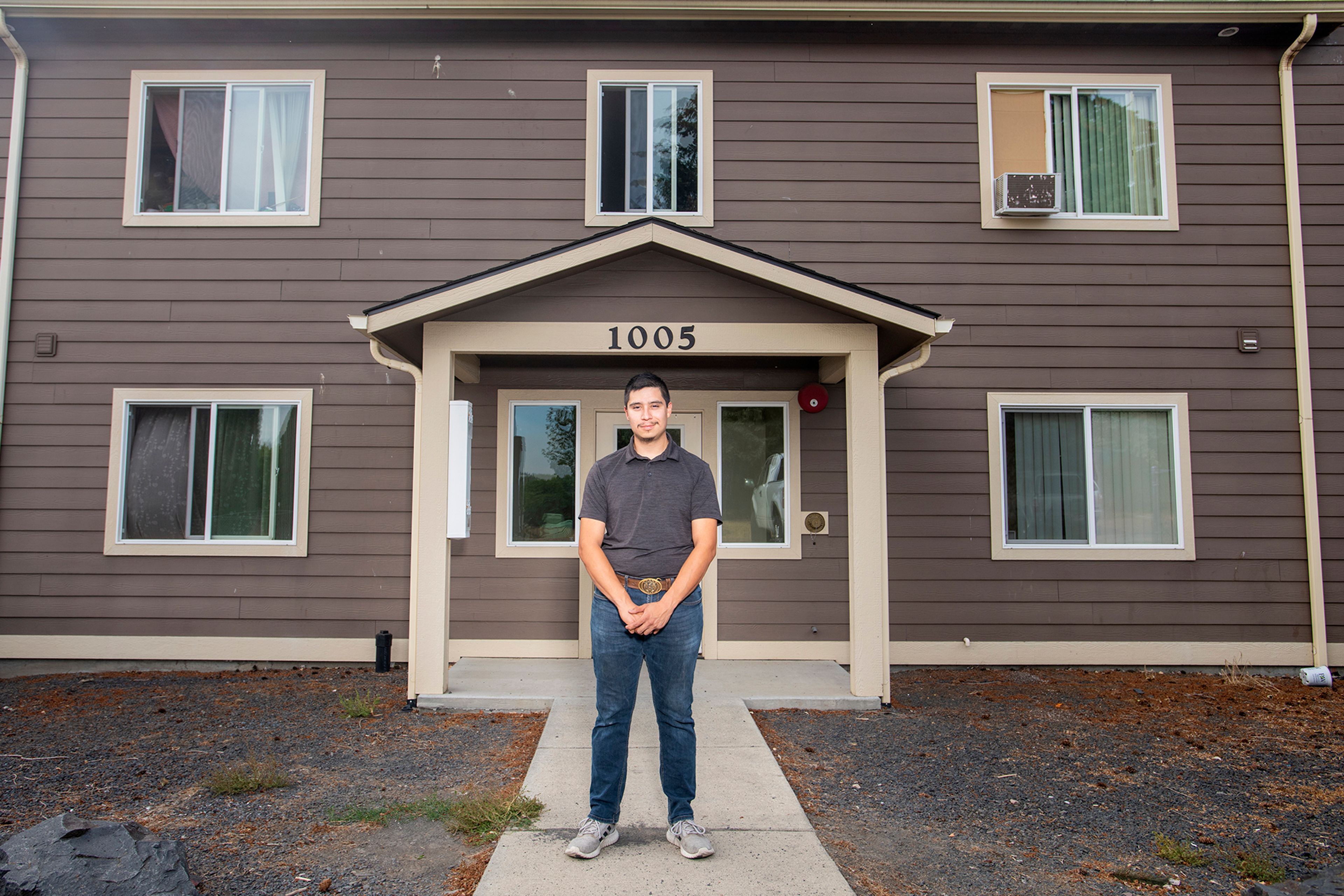 David Gutierrez-Aguirre, of Moscow, stands in front of his current townhouse residence for a portrait as he struggles to find an affordable house to purchase in the area.