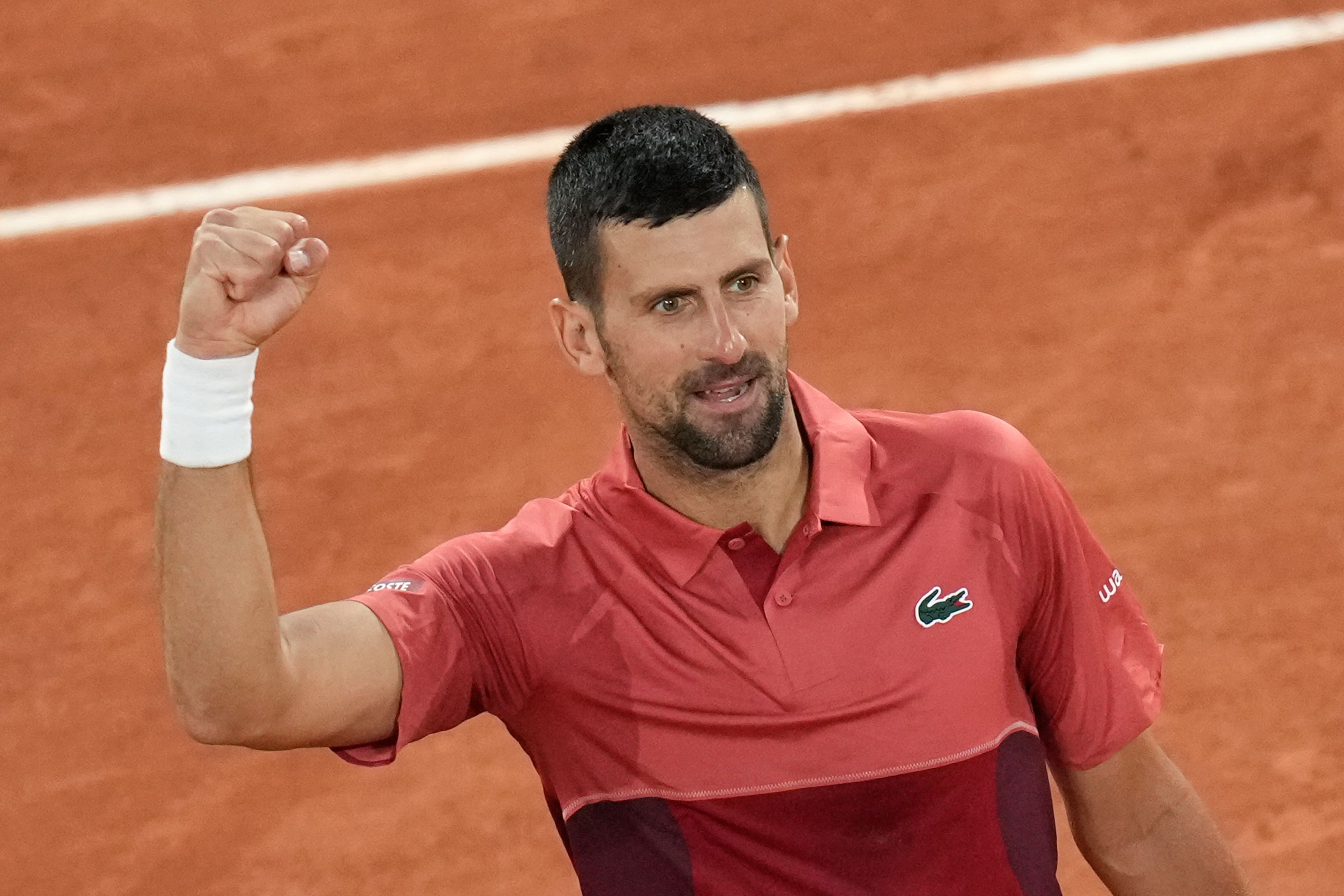 Serbia's Novak Djokovic celebrates winning his first round match of the French Open tennis tournament against France's Pierre-Hugues Herbert at the Roland Garros stadium in Paris, Tuesday, May 28, 2024.