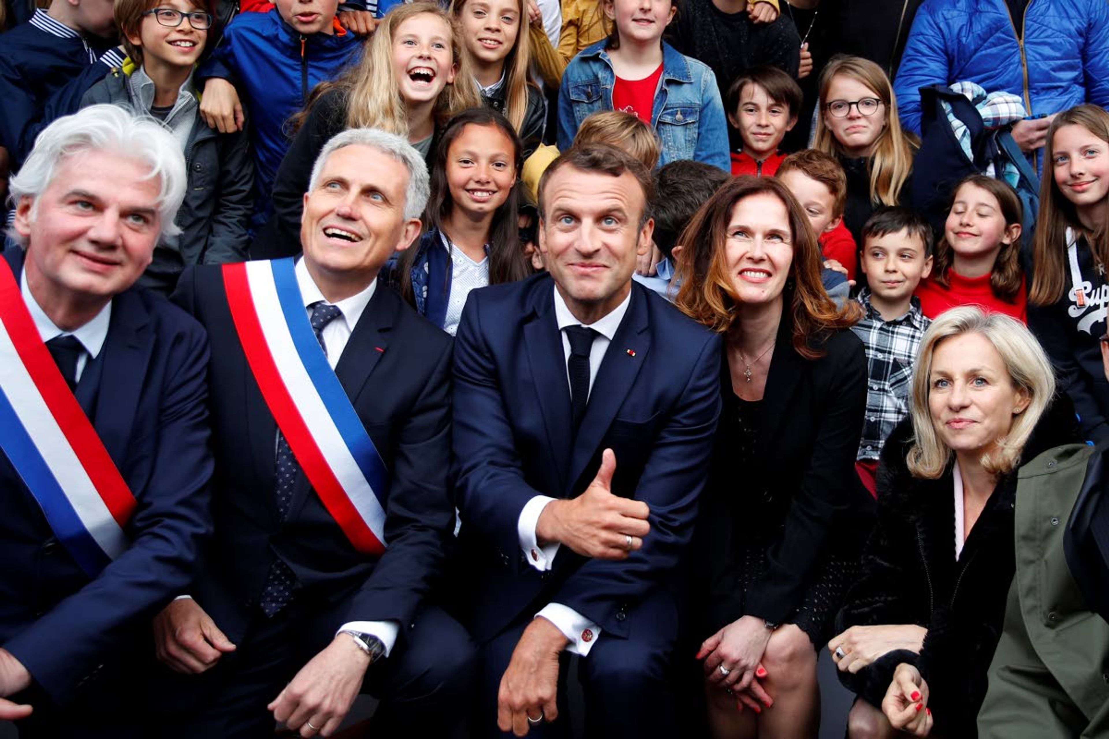 French president Emmanuel Macron poses for a group picture after a ceremony at the Caen prison to pay tribute to French resistants as part of D-Day ceremonies in Caen, Wednesday, June 5, 2019. On June 5, 1944, the Germans have shot 80-85 persons at the prison of Caen, including 71 who have been identified, members of Resistance. (AP Photo/Francois Mori, pool)