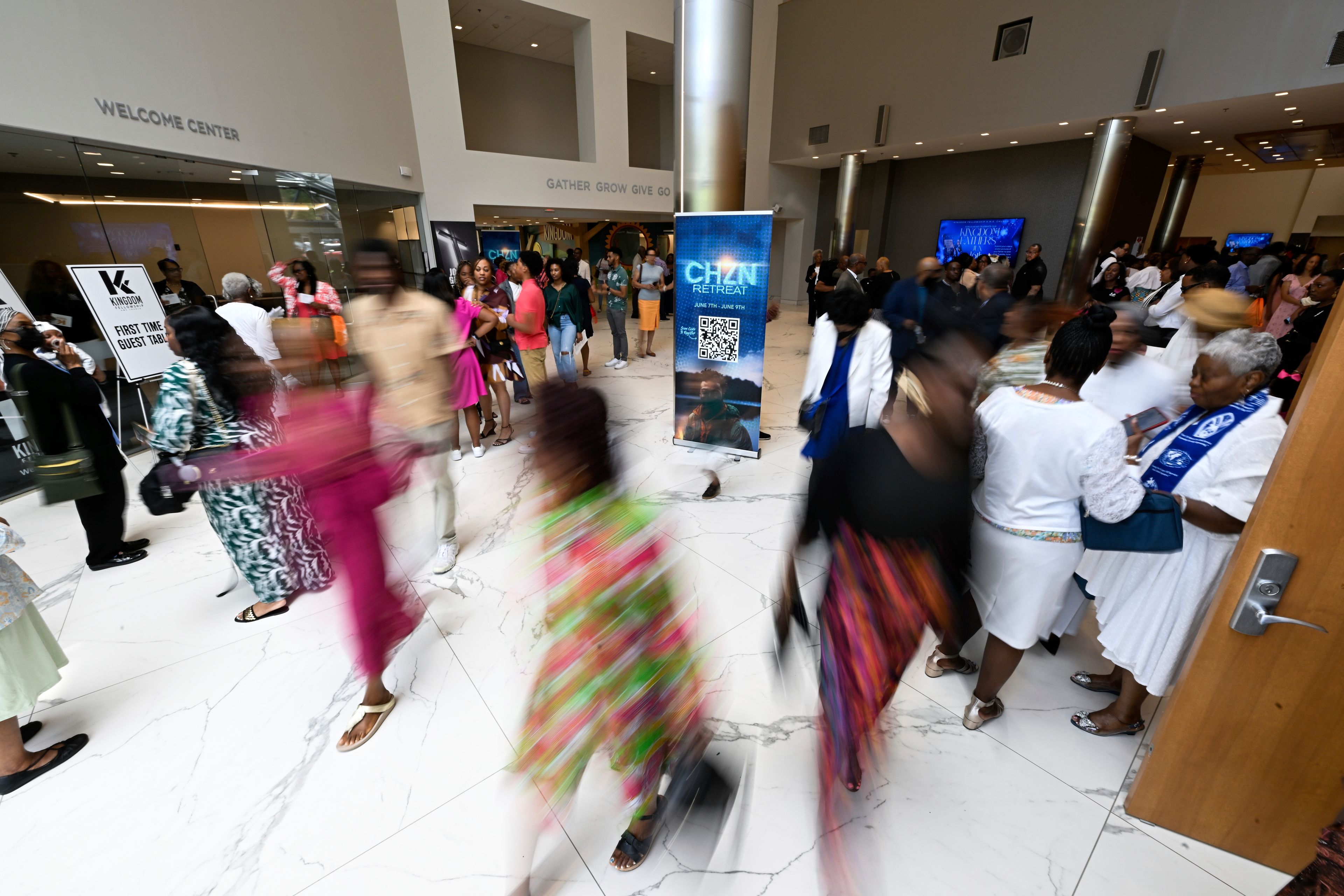 People walk through the corridor of Kingdom Fellowship AME Church after church service, Sunday, June 2, 2024, in Calverton, Md. The suburban Maryland congregation, led by the Rev. Matthew L. Watley, has landed at the top of a list of the fastest-growing churches in America.