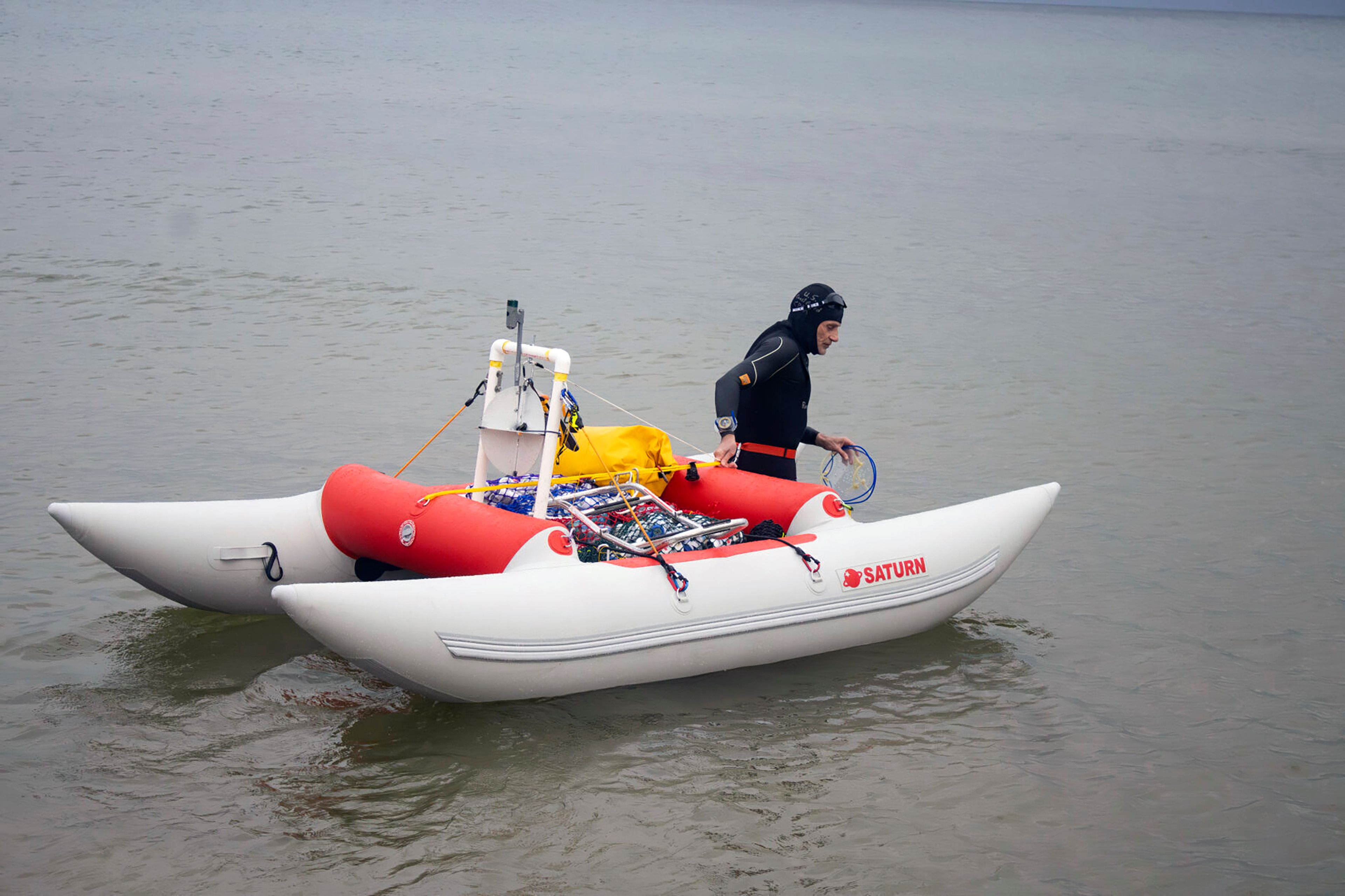 Jim Dreyer heads out into Lake Michigan in Grand Haven, Mich., Aug. 6, 2024, in his attempt to swim to Wisconsin.