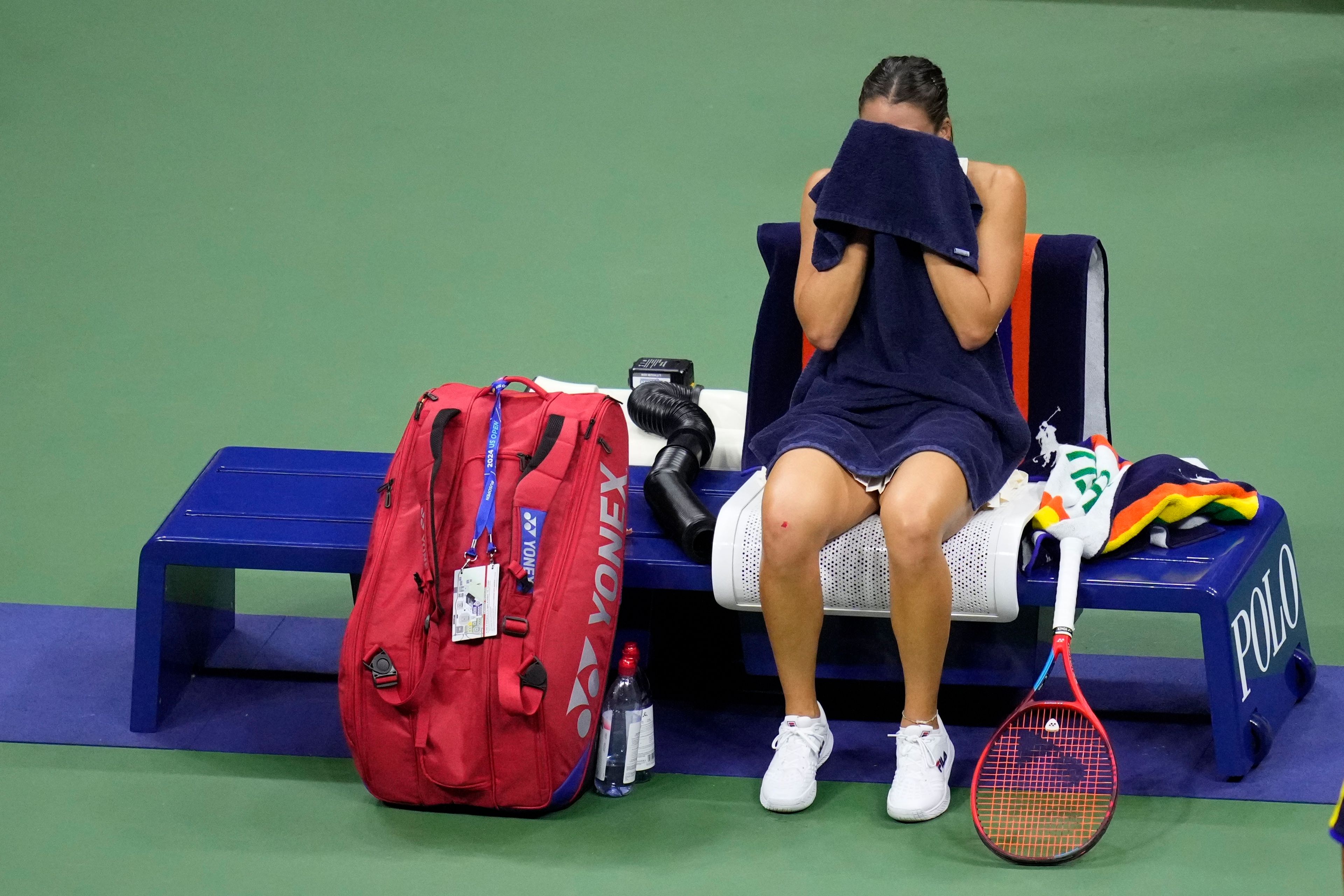 Emma Navarro, of the United States, wipes her face during the women's singles semifinals against Aryna Sabalenka, of Belarus, of the U.S. Open tennis championships, Thursday, Sept. 5, 2024, in New York.