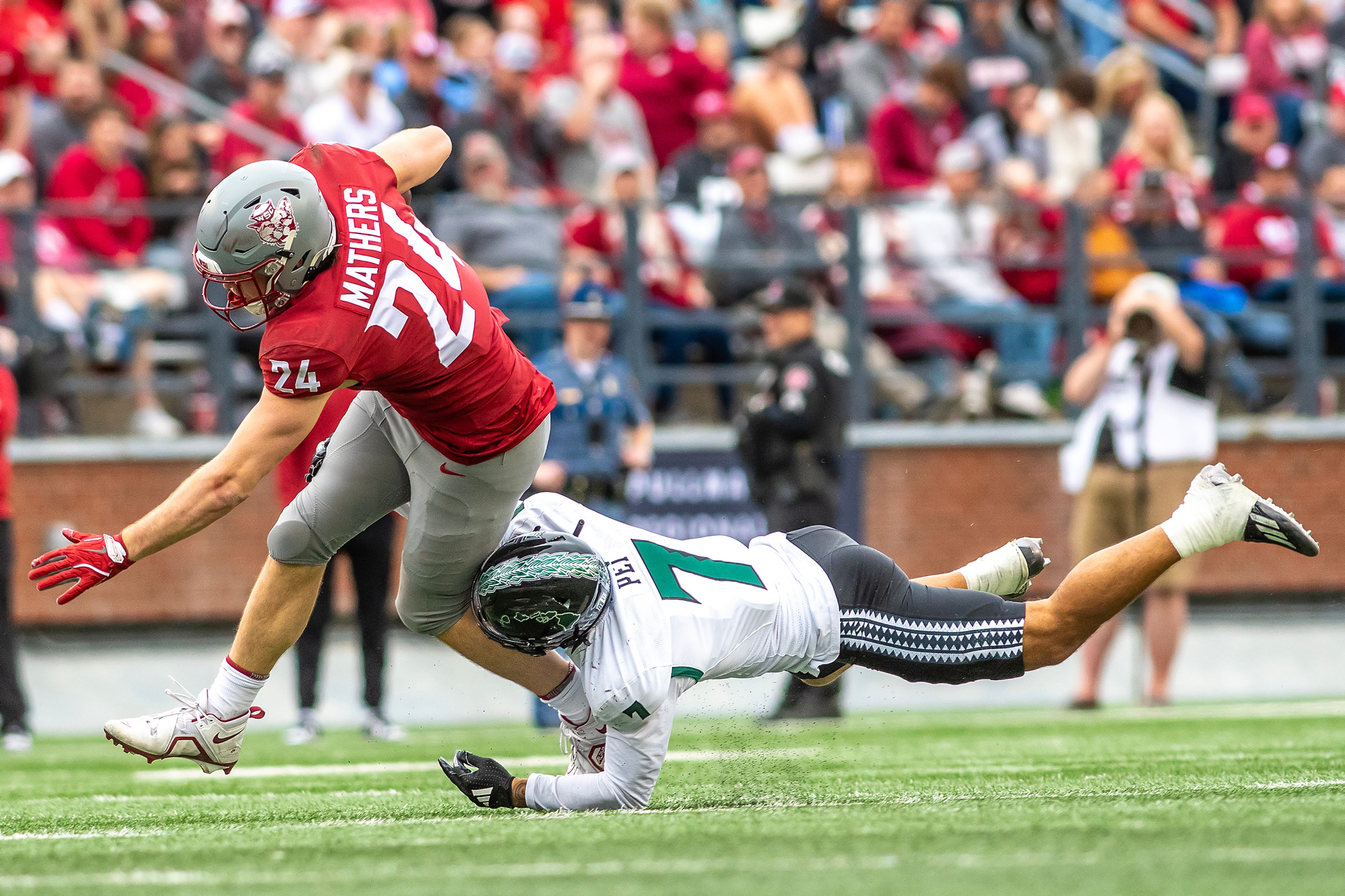 Washington State tight end Cooper Mathers attempts to avoid a tackle from Hawaii defensive back Meki Pei in a college football game on Saturday at Gesa Field in Pullman. WSU defeated Hawaii 42-10.,