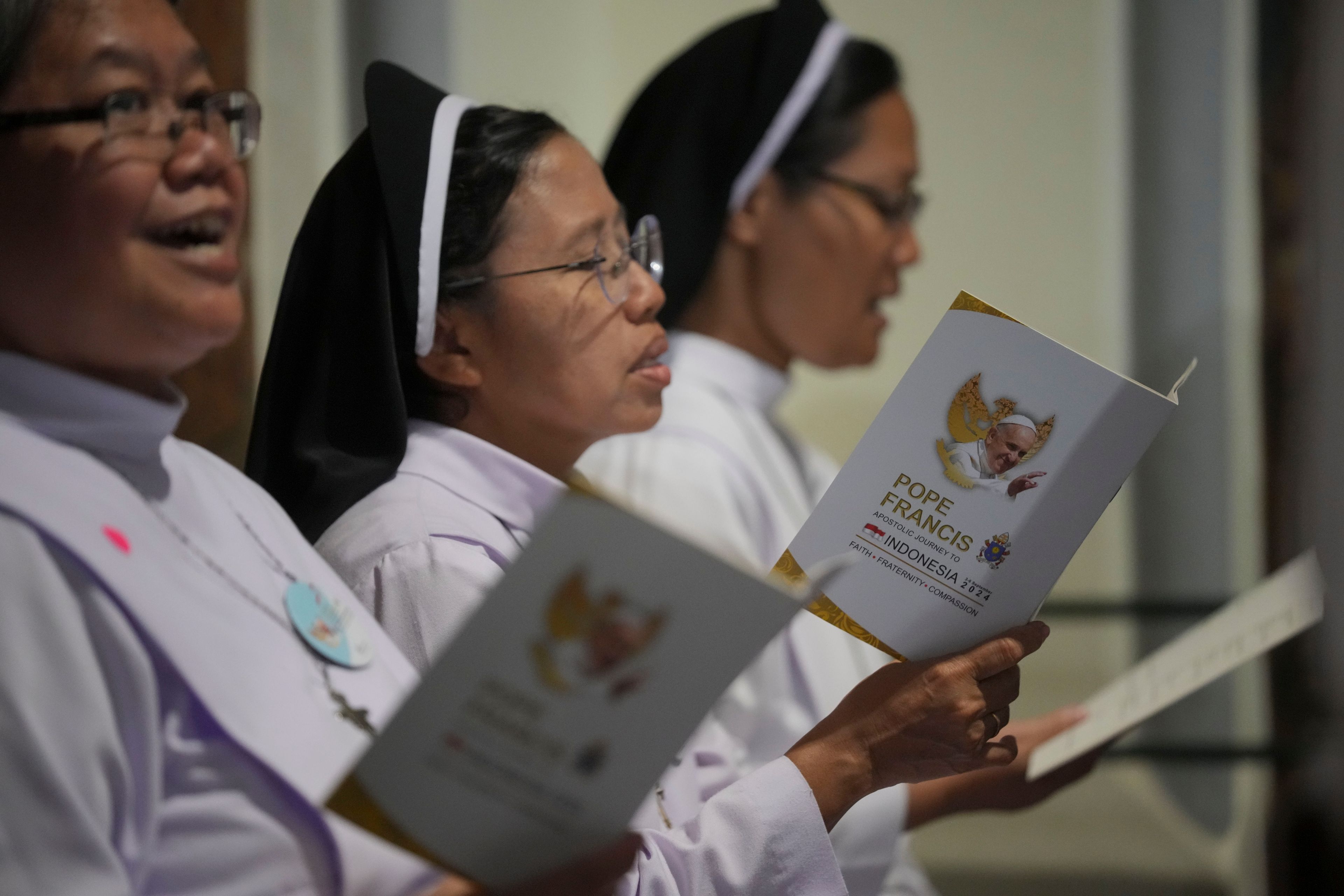 Nuns pray before the arrival of Pope Francis at the Cathedral of Our Lady of the Assumption, in Jakarta, Indonesia, Wednesday, Sept. 4, 2024.