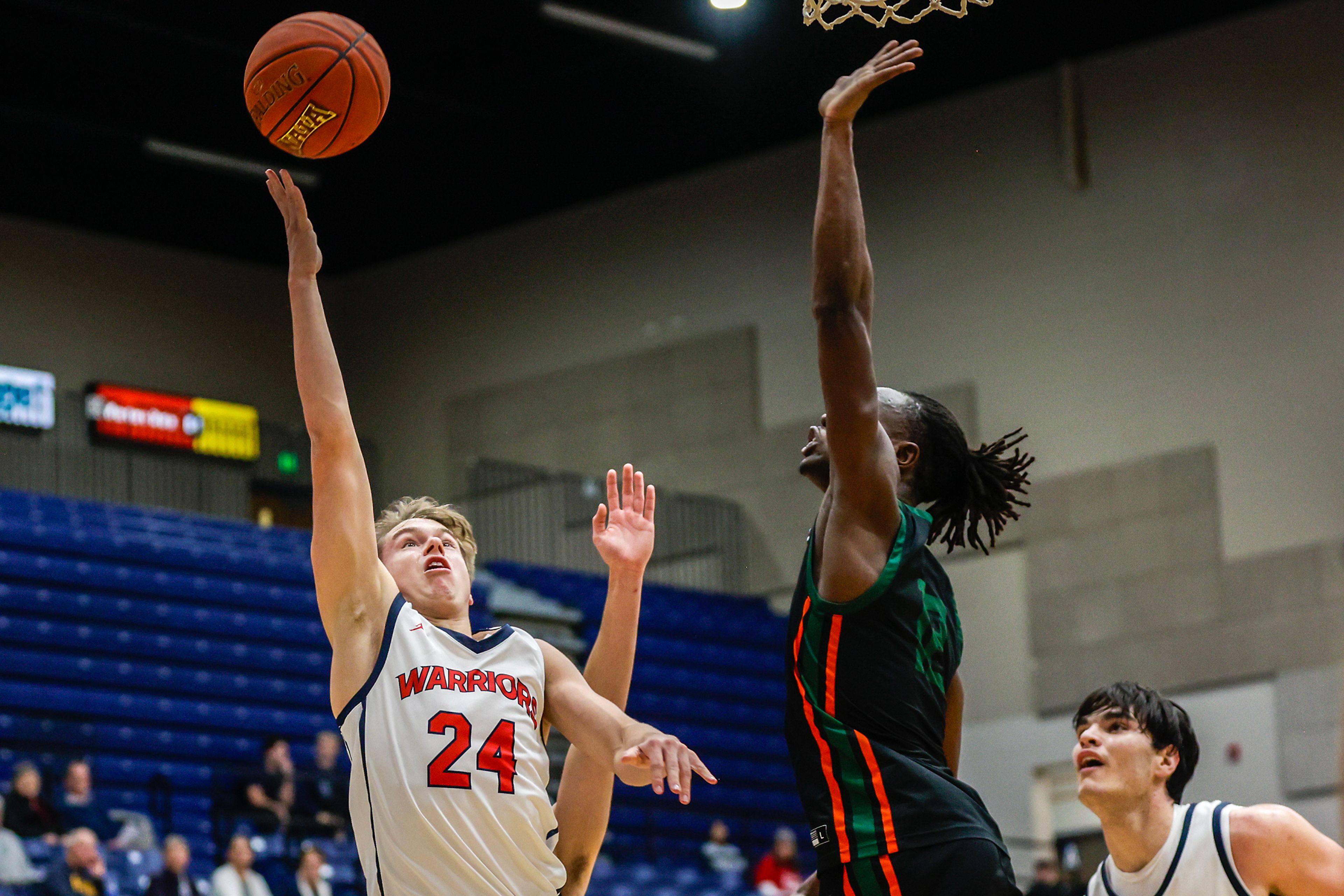 Lewis-Clark State guard Peyton Nordland shoots the ball as Walla Walla forward Almonds Sebirokwa guards him during a quarter of a Cascade Conference game Tuesday at Lewis-Clark State College in Lewiston.