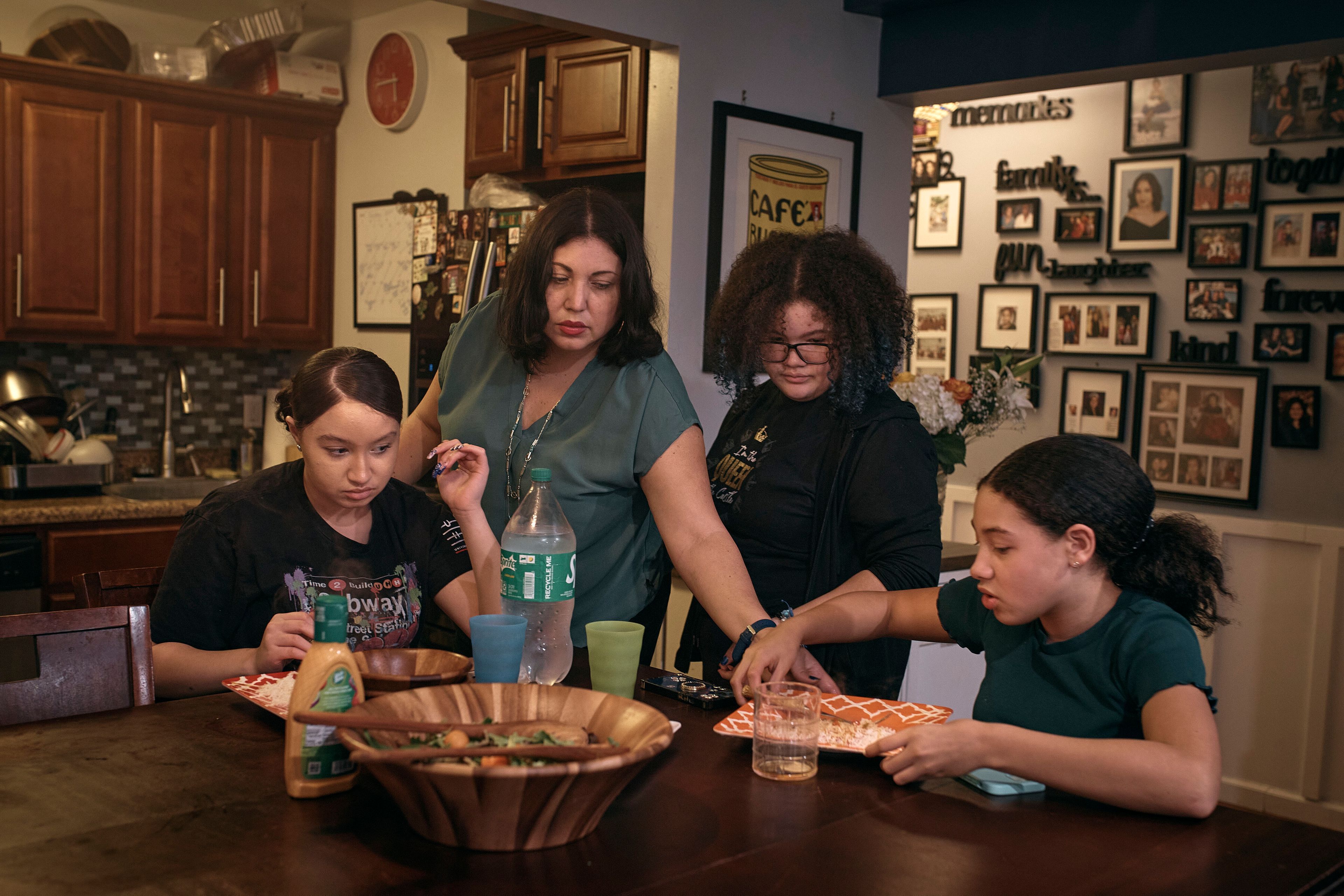 Elena Romero, second from left, and her daughters Gabriela Durham, 17, left, Gionna Durham, 13 second from right, and Grace Durham, 11, have dinner together on Saturday, Jan. 27, 2024, in New York. With the damaging consequences of social media increasingly well documented, many parents are trying to raise their children with restrictions or blanket bans. Teenagers themselves are aware that too much social media is bad for them, and some are initiating social media “cleanses” because of the toll it takes on mental health and grades.