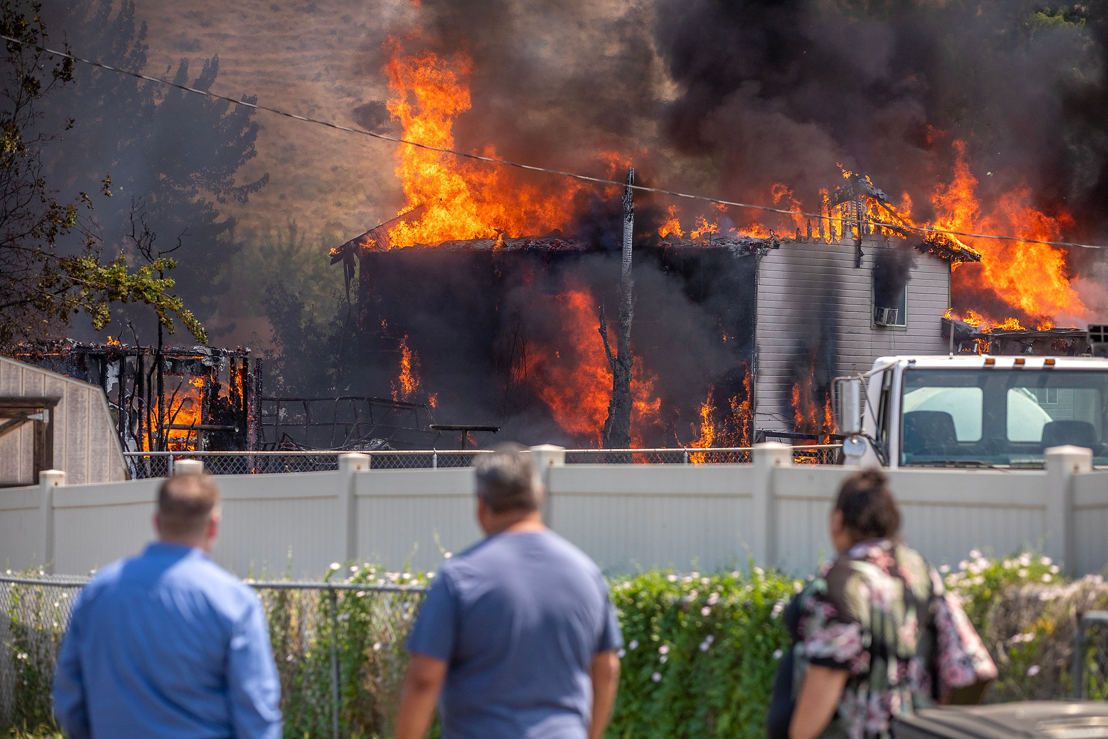 People look on at the the scene of a structure fire Friday on Lolo Street in Lapwai.