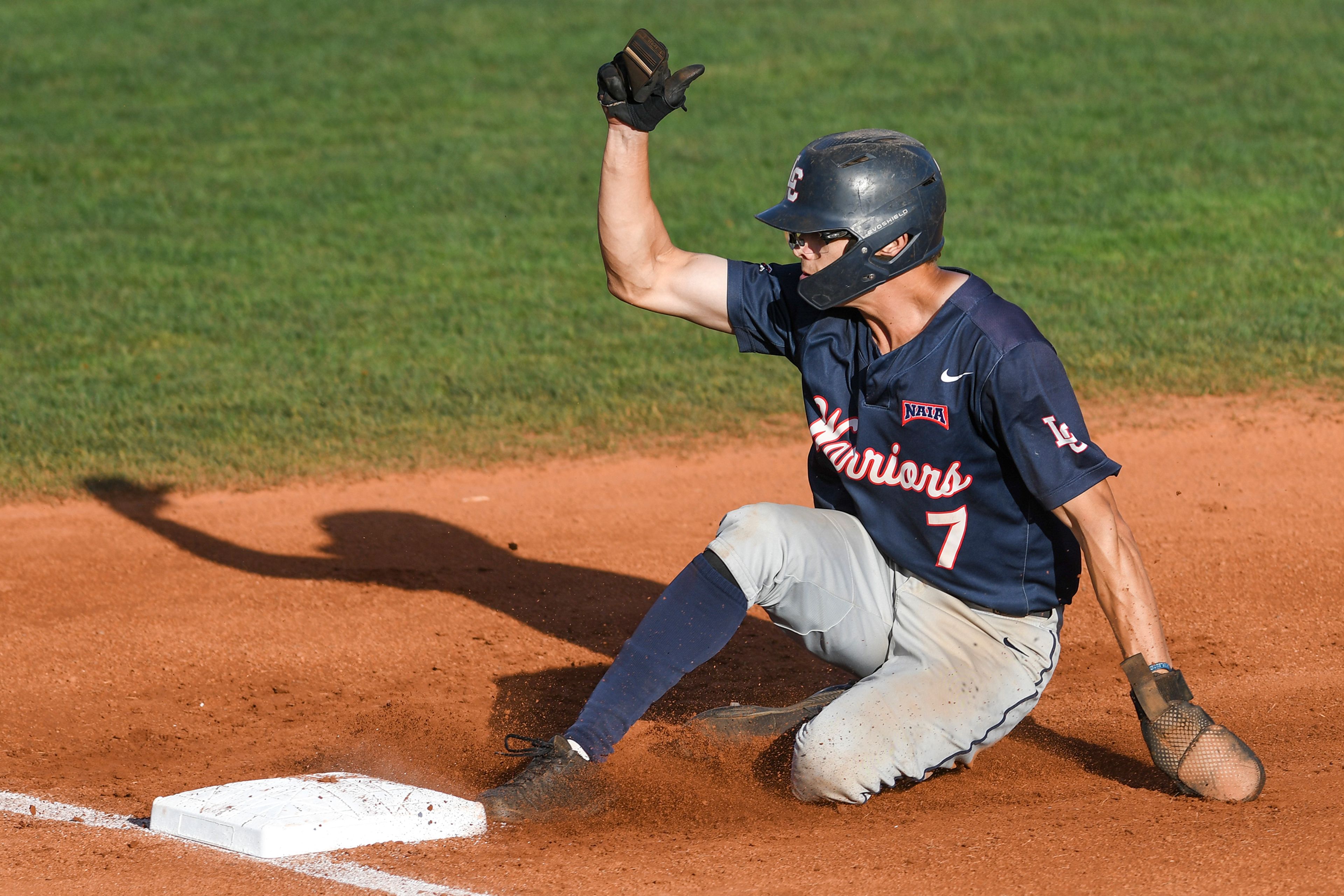 Lewis-Clark State’s Nick Seamons slides back into first base against Westmont during Game 19 of NAIA World Series at Harris Field in Lewiston on Friday.